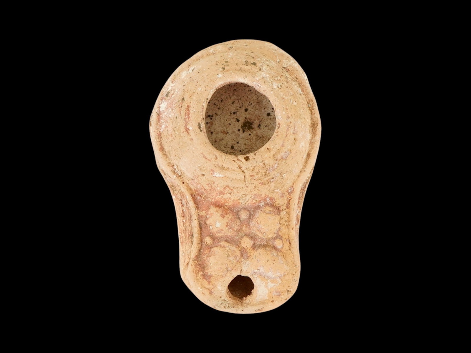 ANCIENT SAMARITAN JUDAICA TERRACOTTA OIL LAMP: An ancient Samaritan Judaica moulded terracotta pottery oil lamp, known as a slipper lamp. The body of the lamp is hand painted and adorned with engraved ornaments. The lamp is decorated with a raised