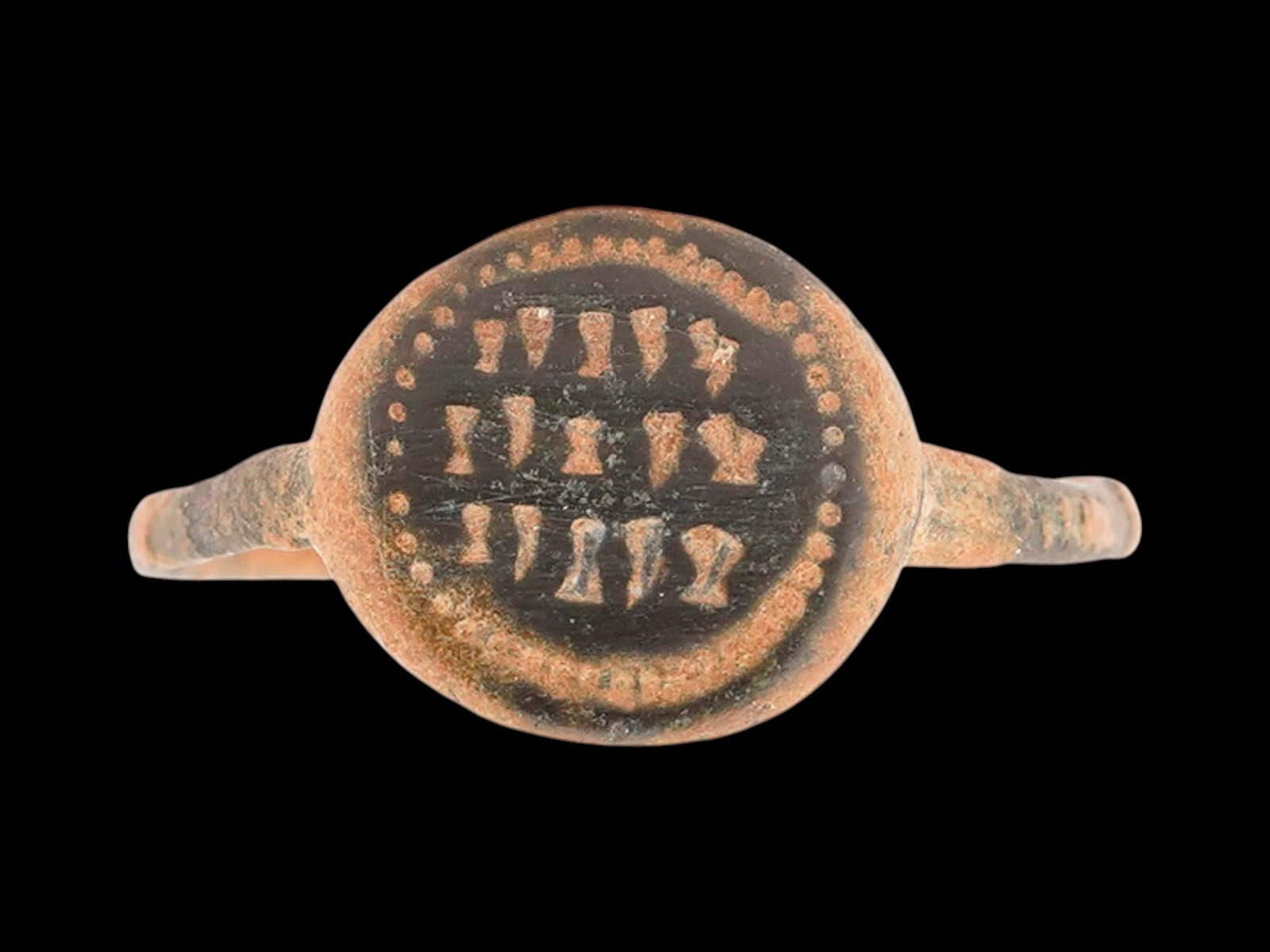 ANCIENT JUDAICA MAGICAL BLESSING 3 LINES INSCRIPTION RING: An ancient Judaica Late Roman bronze signet ring, dating from 300 to 450 AD. The ring features a round bezel engraved with three lines of magical blessing inscriptions and a circular motif to the edge