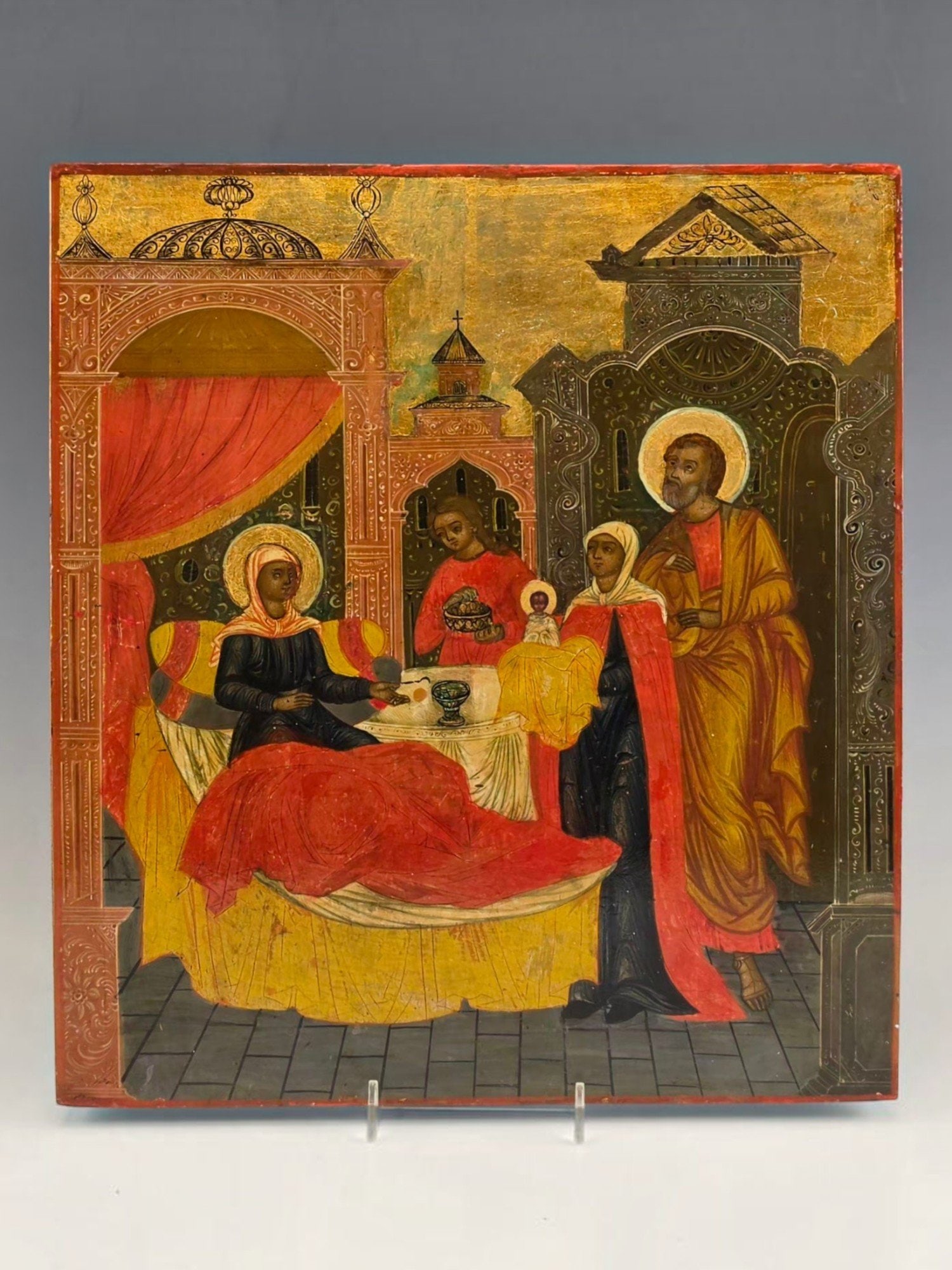 19TH CEN RUSSIAN ICON OF THE PRESENTATION IN THE TEMPLE: A 19th century Russian icon depicting the Presentation of Christ in the Temple Sretenie. Tempera and gold leaf on wood panel. The composition shows the Virgin Mary presenting the Christ Child before S