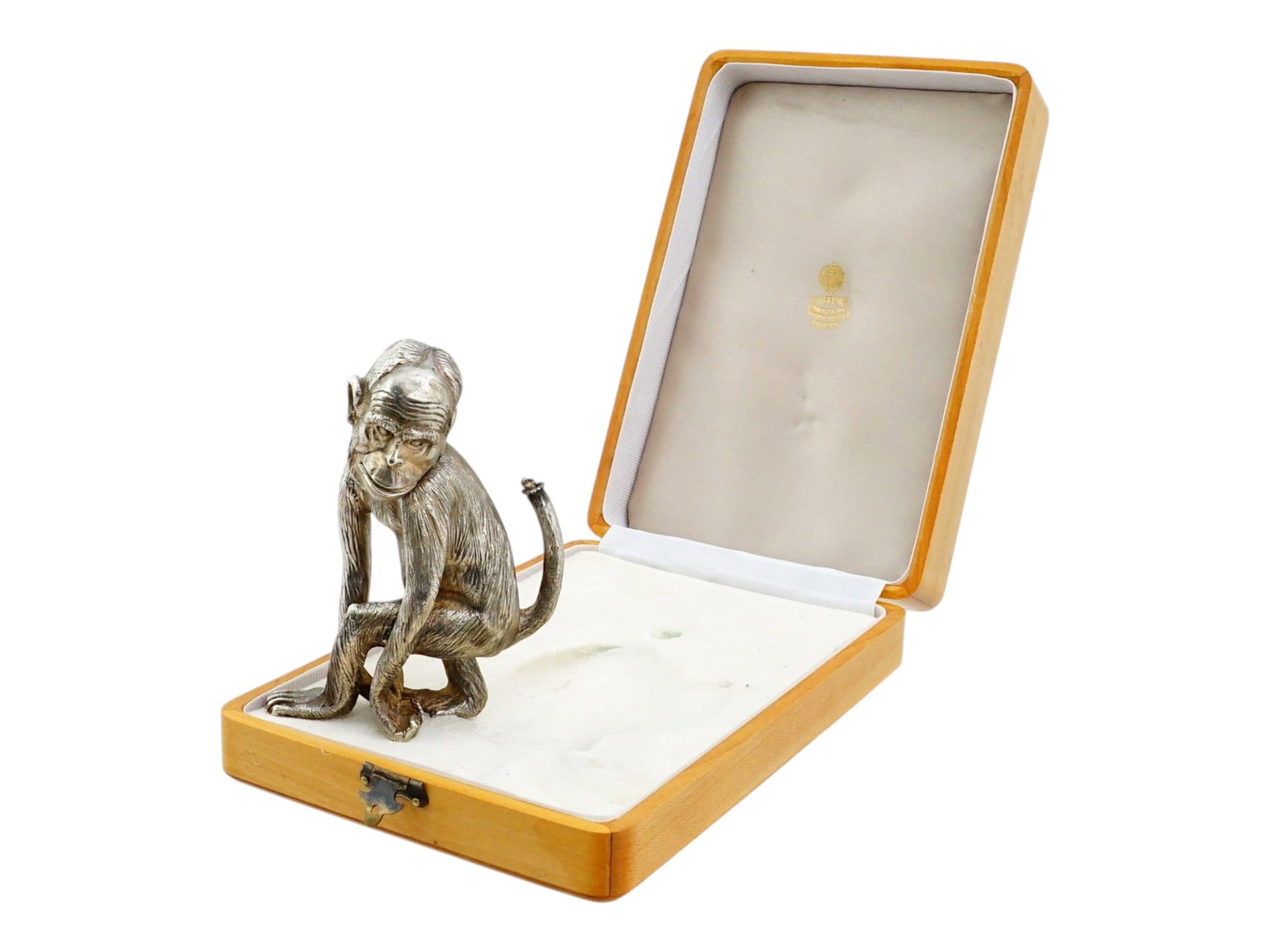 RUSSIAN MONKEY FIGURAL SILVER DESK LIGHTER IN BOX: A Russian silver desk lighter modeled in the form of a seated monkey, featuring a naturalistically chased surface to simulate fur. The head is hinged at the neck to provide access to the interior cham