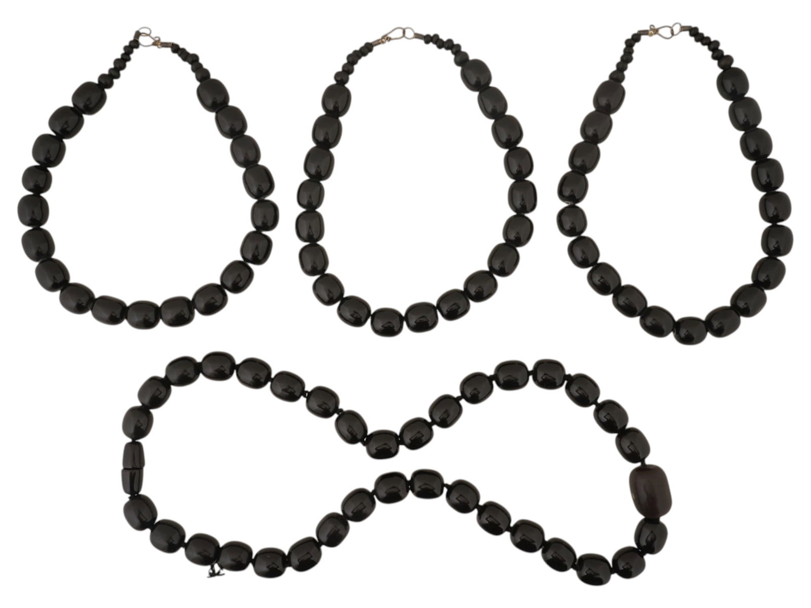 LOT OF GRADUATED BEADED COSTUME JEWELRY NECKLACES: A collection of four graduated necklaces featuring matte black plastic molded beads. Three of the necklaces are of similar choker length, while the fourth is a longer strand. Each piece is constructed