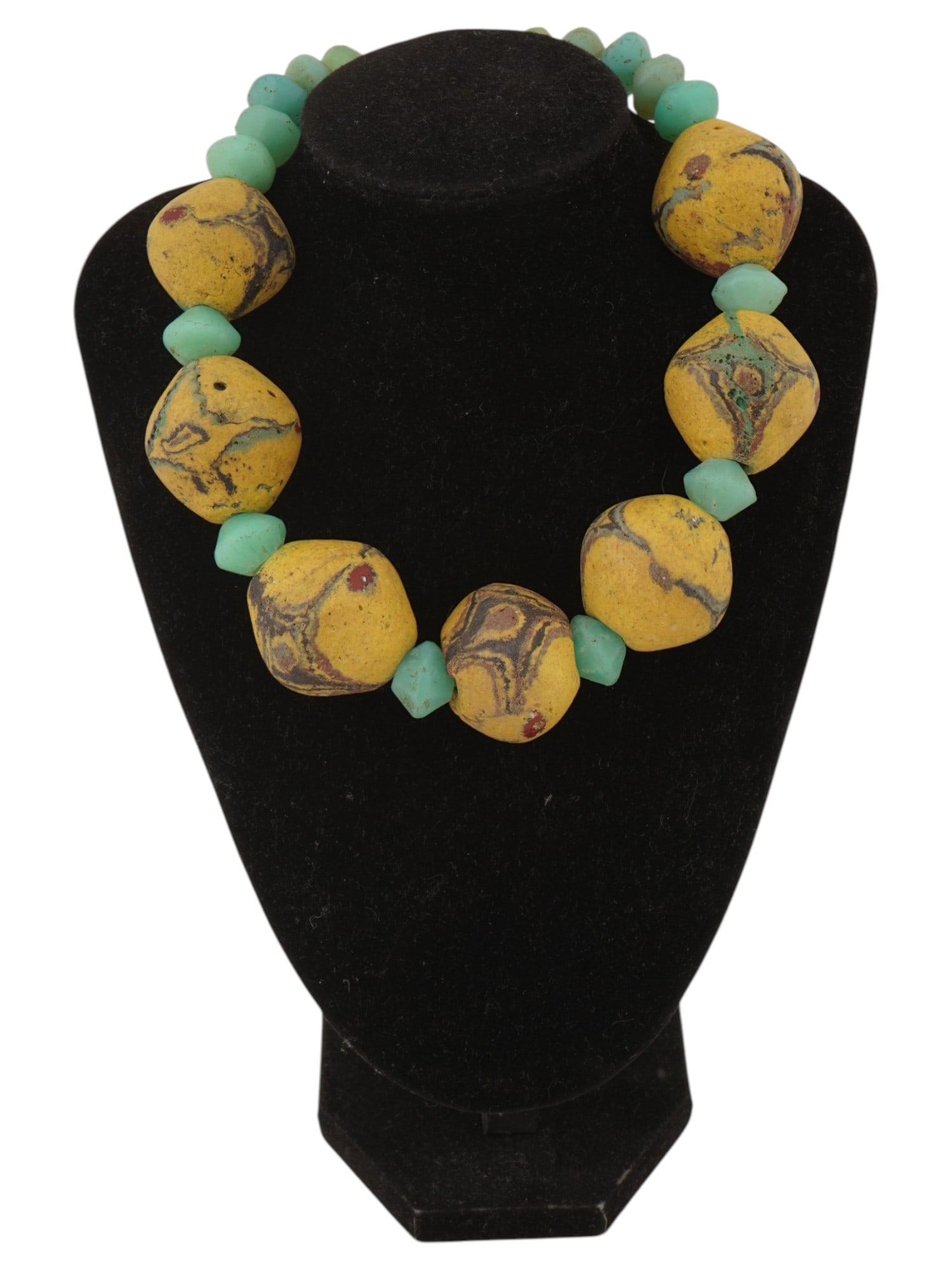 VINTAGE AFRICAN STYLE GLASS BEADED NECKLACE: A vintage glass beaded necklace. North African style, composed of turquoise-color bicone beads and large patterned yellow beads. Toggle clasp. Costume Jewelry, Statement Fashion Accessories. THIS LOT 