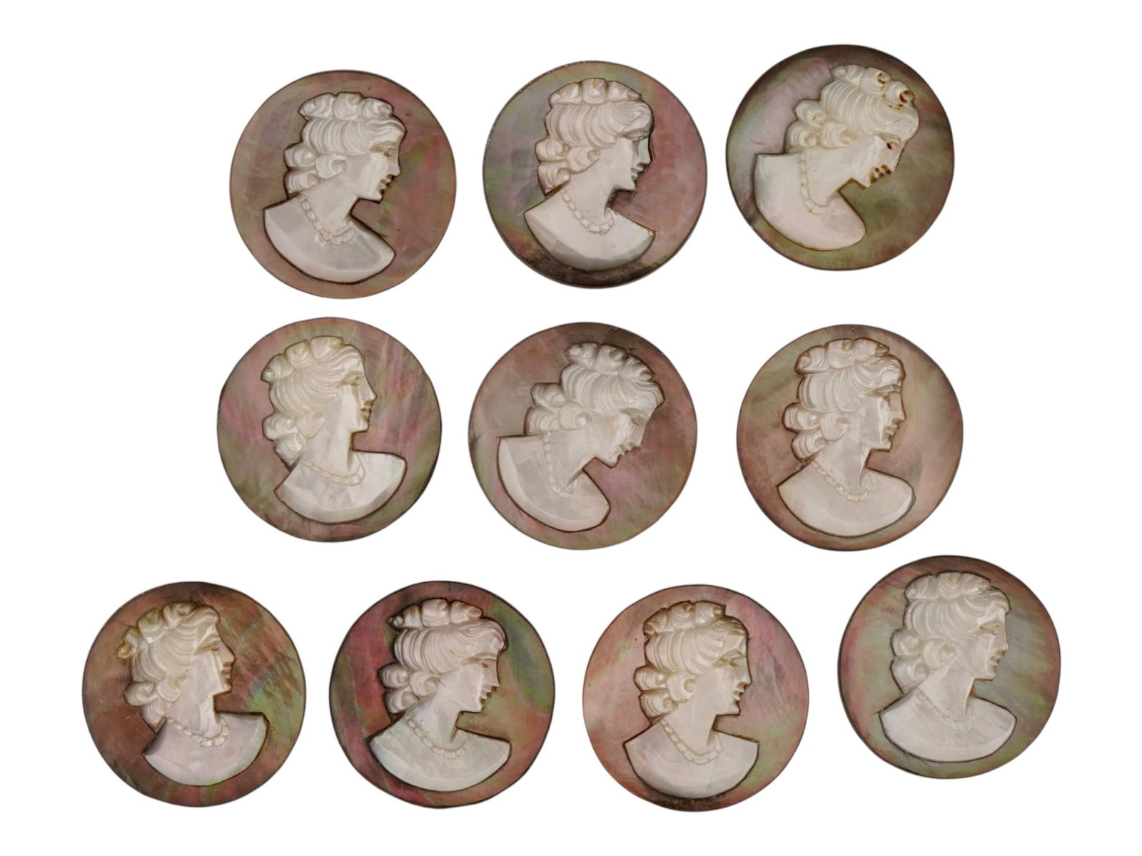 COLLECTION OF HAND CARVED SHELL CAMEO MEDALLIONS: A collection of vintage hand carved cameo medallions. A total of 10 items. Each piece is crafted from conch shell featuring a female portrait in the Victorian manner rendered in high relief. The cameo