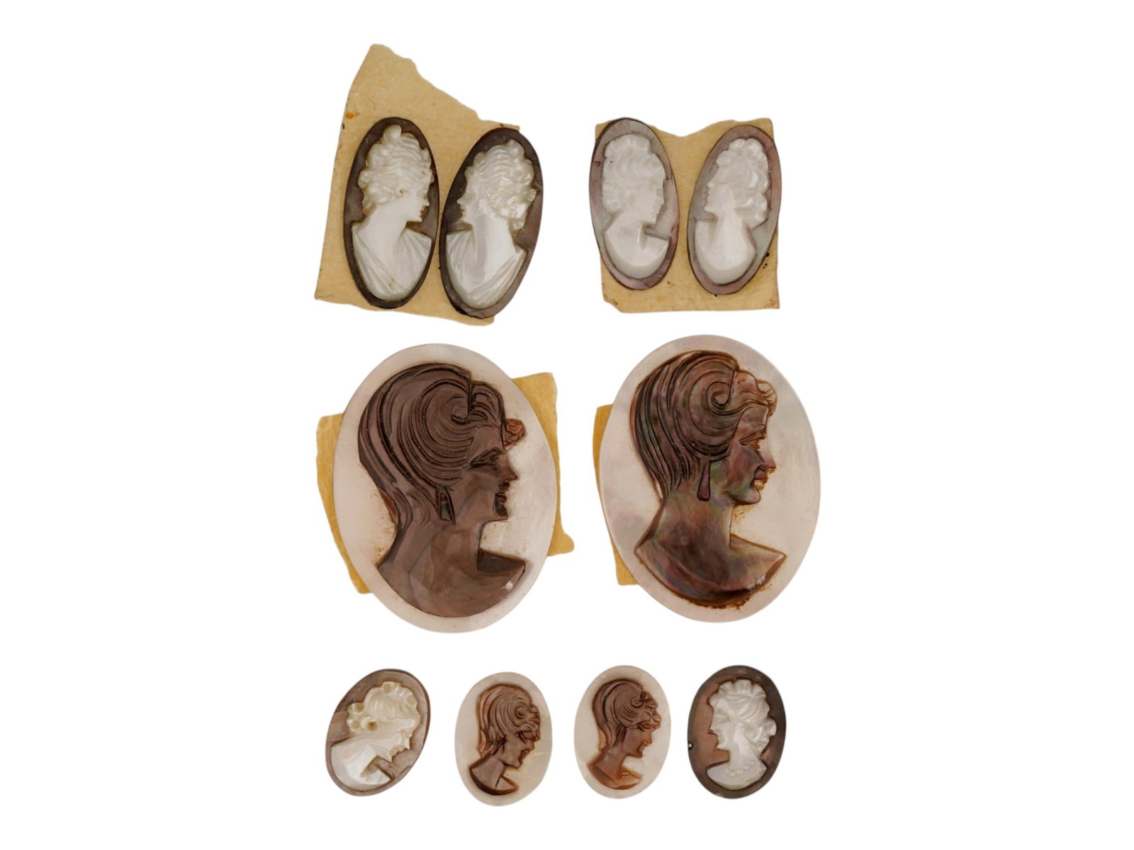 COLLECTION OF HAND CARVED SHELL CAMEO MEDALLIONS: A collection of vintage hand carved cameo medallions. A total of 10 items. Each piece is crafted from conch shell featuring a female portrait in the Victorian manner rendered in high relief. The cameo