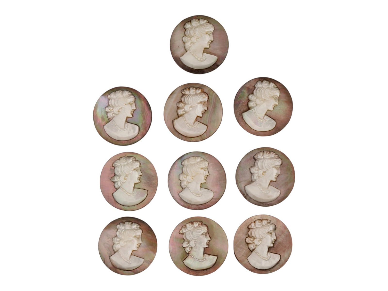 COLLECTION OF FEMALE PORTRAIT CARVED SHELL CAMEOS: A collection of hand carved shell cameos. A total of 10 items. Each piece features female profile portraits rendered in high relief. Round shape. Collectible Jewelry And Glyptic Art, Sculpture. THIS L