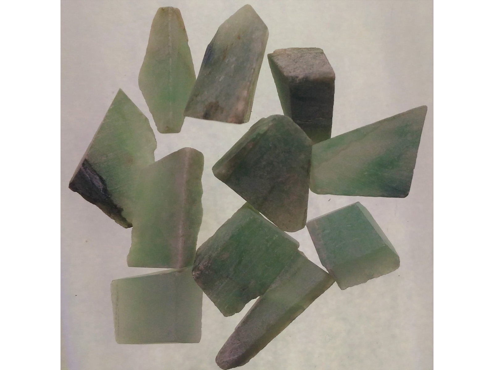 GENUINE JADEITE JADE CUT PIECES - SET OF 11: Set of 11 jadeite jade cut pieces (jad2/15). Combined weight: 13.17 grams. Origin: Hpkant, Kachin State, Myanmar. THIS LOT QUALIFIES FOR A 30-DAY UNCONDITIONAL RETURN FROM THE DATE OF SALE. BUYERS