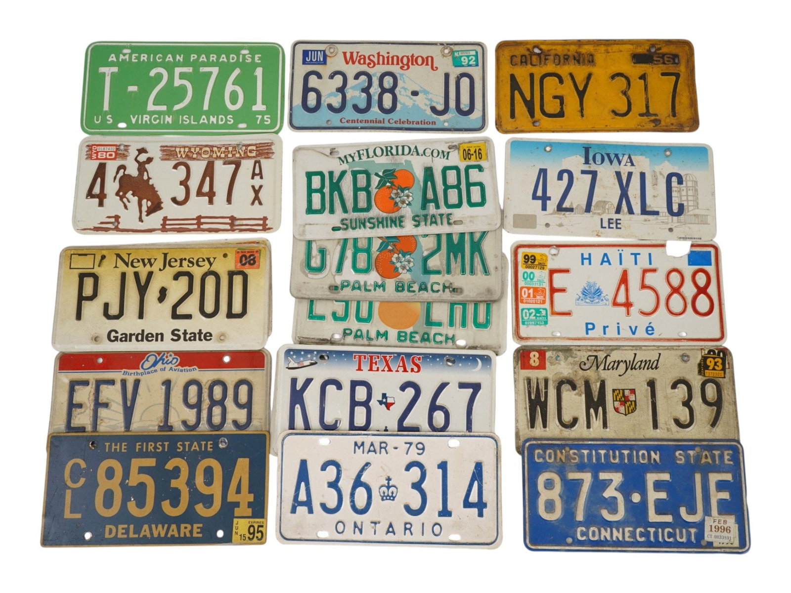 VINTAGE UNITED STATES AND HAITI LICENSE PLATES: A collection of vintage American and Haitian vehicle registration plates. A total of 20 items. Pieces from various U.S. states, with markings and inspection stickers. Car Collectibles, Automobilia, Tr