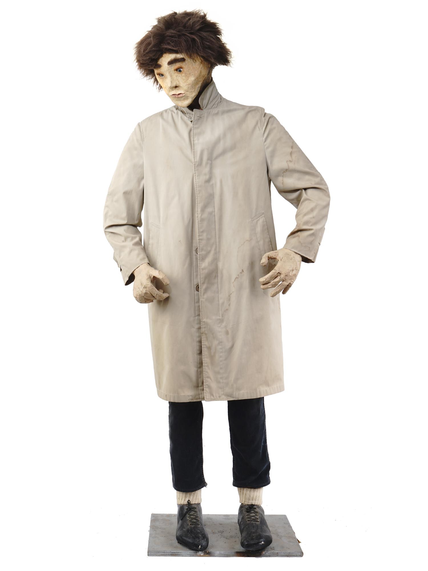 LARGE VINTAGE 1980S PAPIER MACHE SCULPTURE OF MAN: A very fine quality life-sized sculpture of a man made of papier mache with glass eyes and hair made of natural materials, wearing a light-gray coat, black trousers and boots. Unmarked. Circa 1980. Co