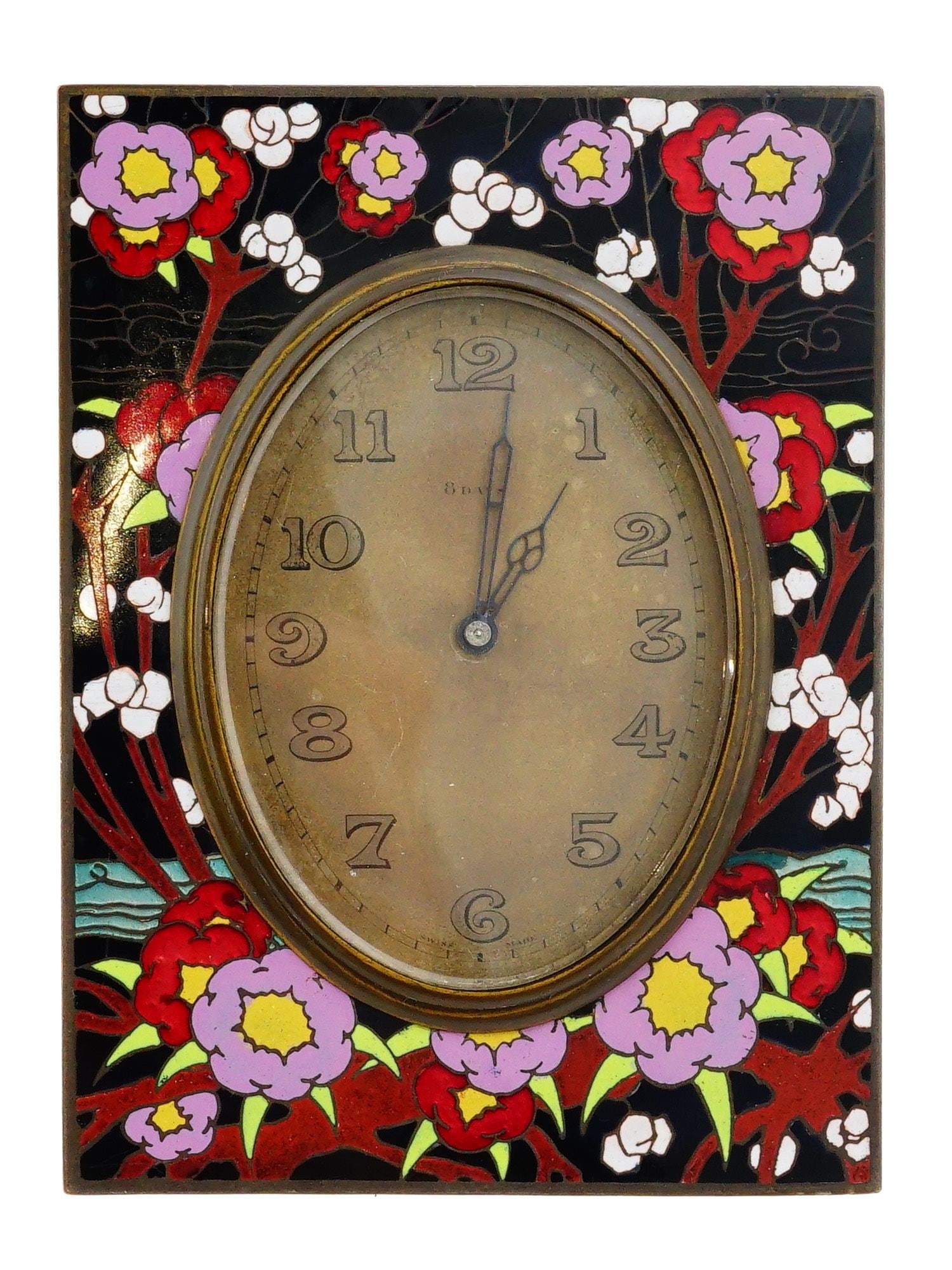 SWISS EIGHT DAYS ZENITH WATCH CO DESK TABLE CLOCK: A Swiss made Eight Days Zenith Watch Co enameled metal table clock. A bronze tone dial with Arabic numerals and ornate strikes. The frame is covered with enamel floral and foliage in red, white, and p