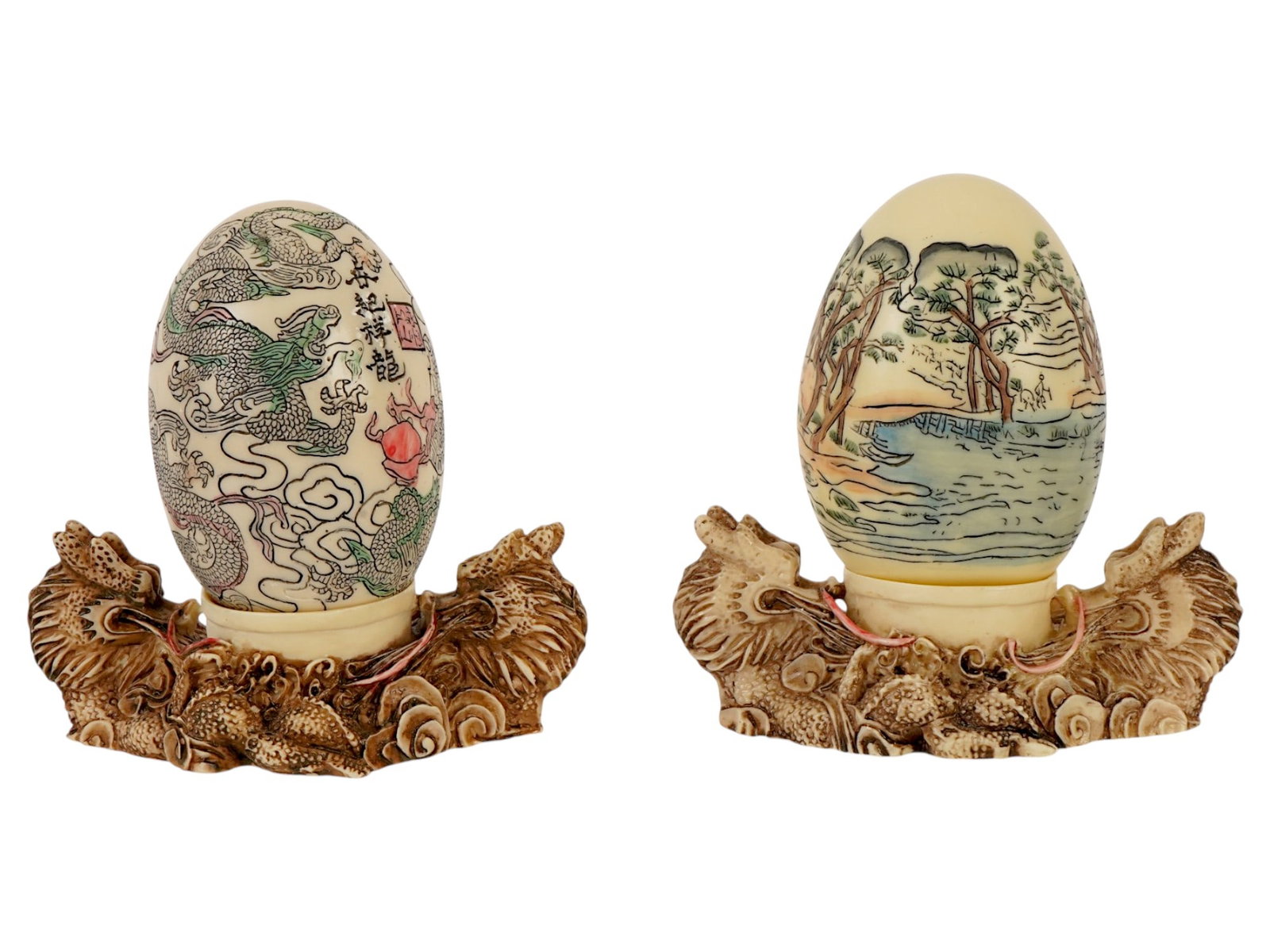 VTG CHINESE DECORATIVE EGGS W CARVED DRAGON STANDS: A pair of vintage Chinese decorative eggs features intricate hand-painted artistry, with one displaying a powerful Imperial dragon amidst stylized clouds and calligraphy, while the other depicts a ser