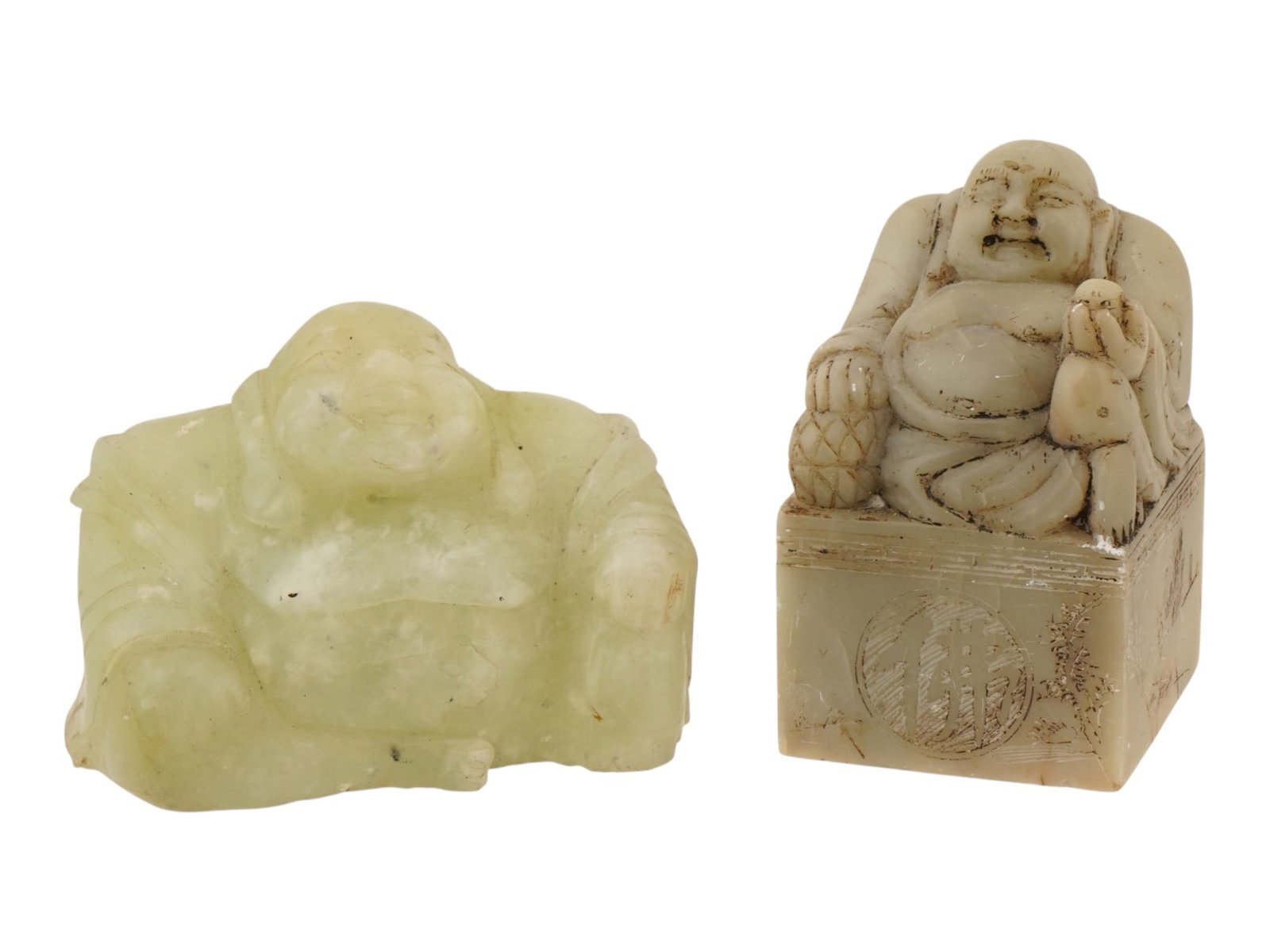 CHINESE JADE BUDAI FIGURINE AND SOAPSTONE STAMP SEAL: A lot of two vintage Chinese Budai carvings. The lot includes a jade Budai figurine and a rectangular soapstone stamp seal with a Budai figurine on top. Budai, or the Laughing Buddha, is one of the go