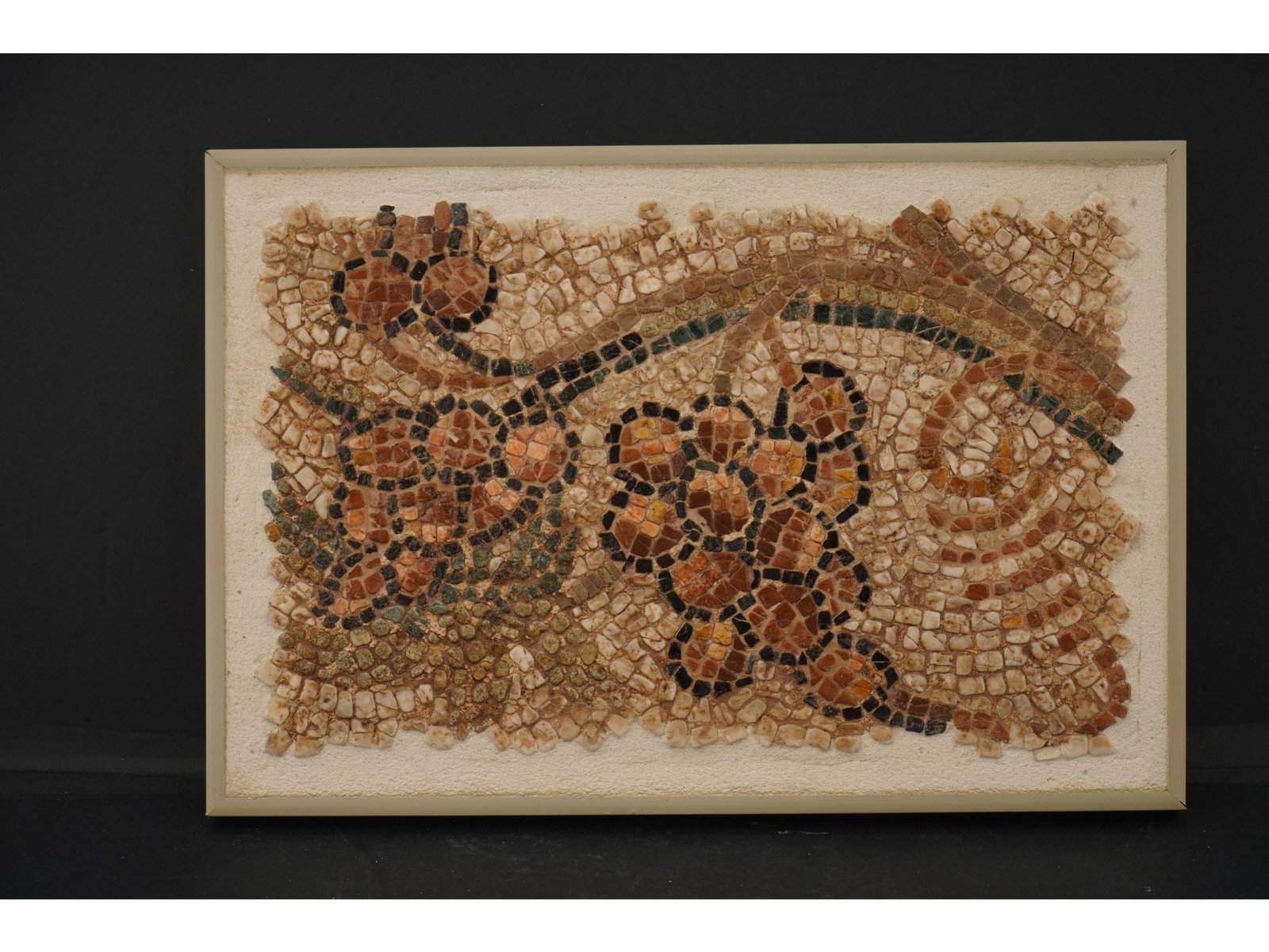 ANCIENT ROMAN MOSAIC OF GRAPE VINE 100 TO 300 AD: An ancient Roman mosaic fragment, showcasing a depiction of a grape vine, reflecting the artistic sophistication and cultural syncretism of the period. Circa 100 to 300 AD. Framed. Mosaics such as thi