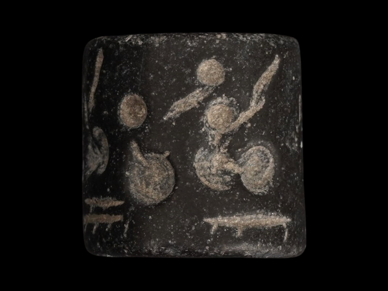 ANCIENT NEAR EASTERN STAMP SEAL 3RD TO 2ND MILLENNIUM BC: An ancient Near Eastern rectangular seal, carved from dark steatite and dates to the late 3rd to early 2nd millennium BC. The body is engraved with a continuous frieze depicting a series of stylized f