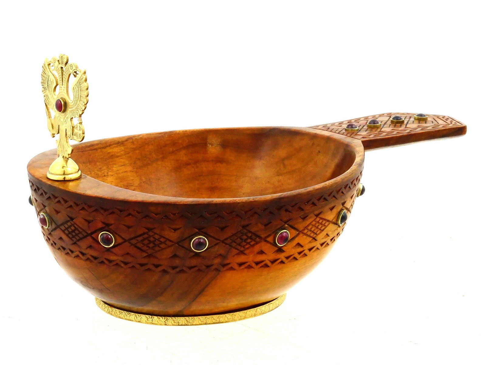 RUSSIAN CARVED WOODEN SILVER AND GEMSTONES KOVSH: A Russian hand carved wooden kovsh with silver and gemstone embellishments. The exterior of the bowl features carved geometric patterns and is set with gemstones. The handle of the bowl is decorated w
