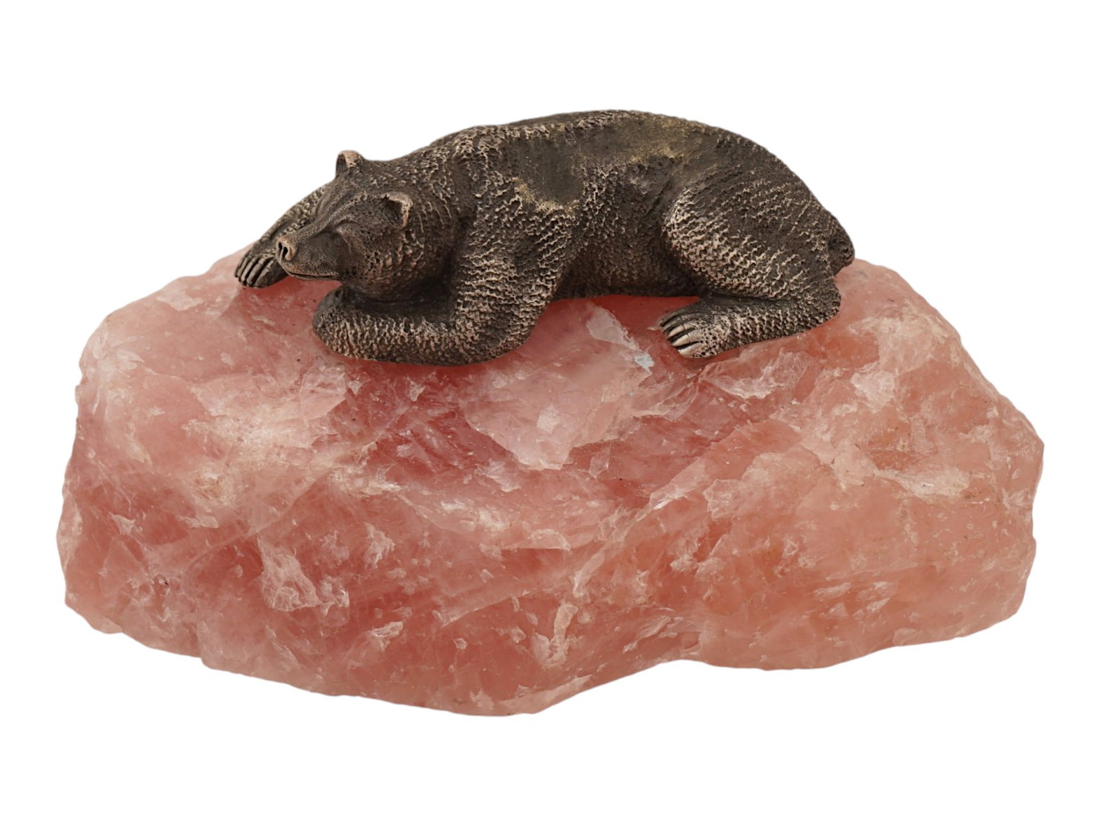 RUSSIAN SILVER BEAR ON ROZE QUARTZ SCULPTURE: A Russian decorative sculpture features a detailed silver figurine of a bear in a recumbent pose, characterized by a textured surface and an intentional dark patina to highlight the fur. The figure is