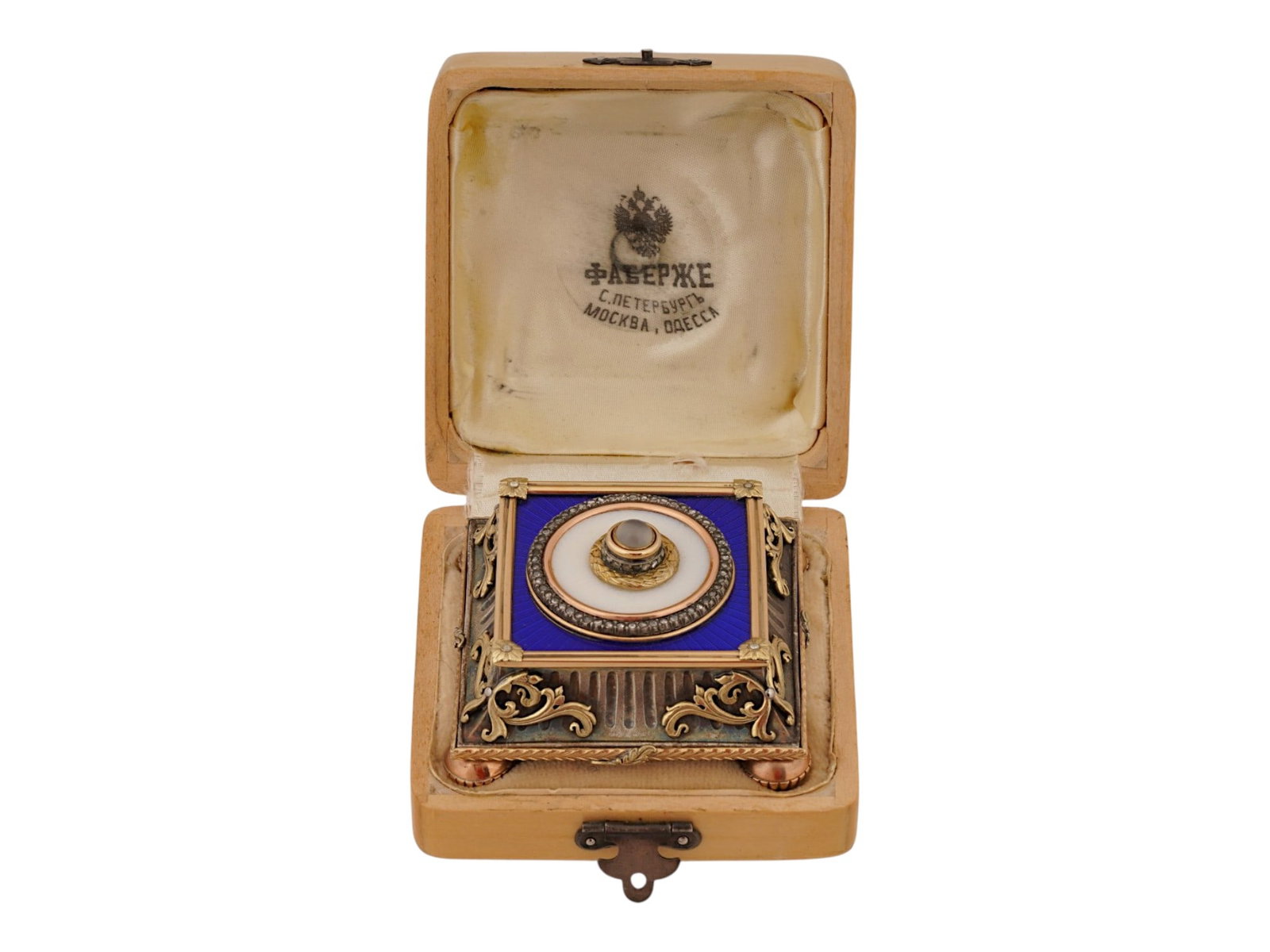 RUSSIAN GOLD ENAMEL PUSH BELL WITH DIAMONDS: A Russian push bell. Footed gold piece garnished with cobalt blue guilloche enamel and overlay in Neoclassical motifs. The cabochon push is encompassed with two rows of diamonds. Hallmark of 56 gold