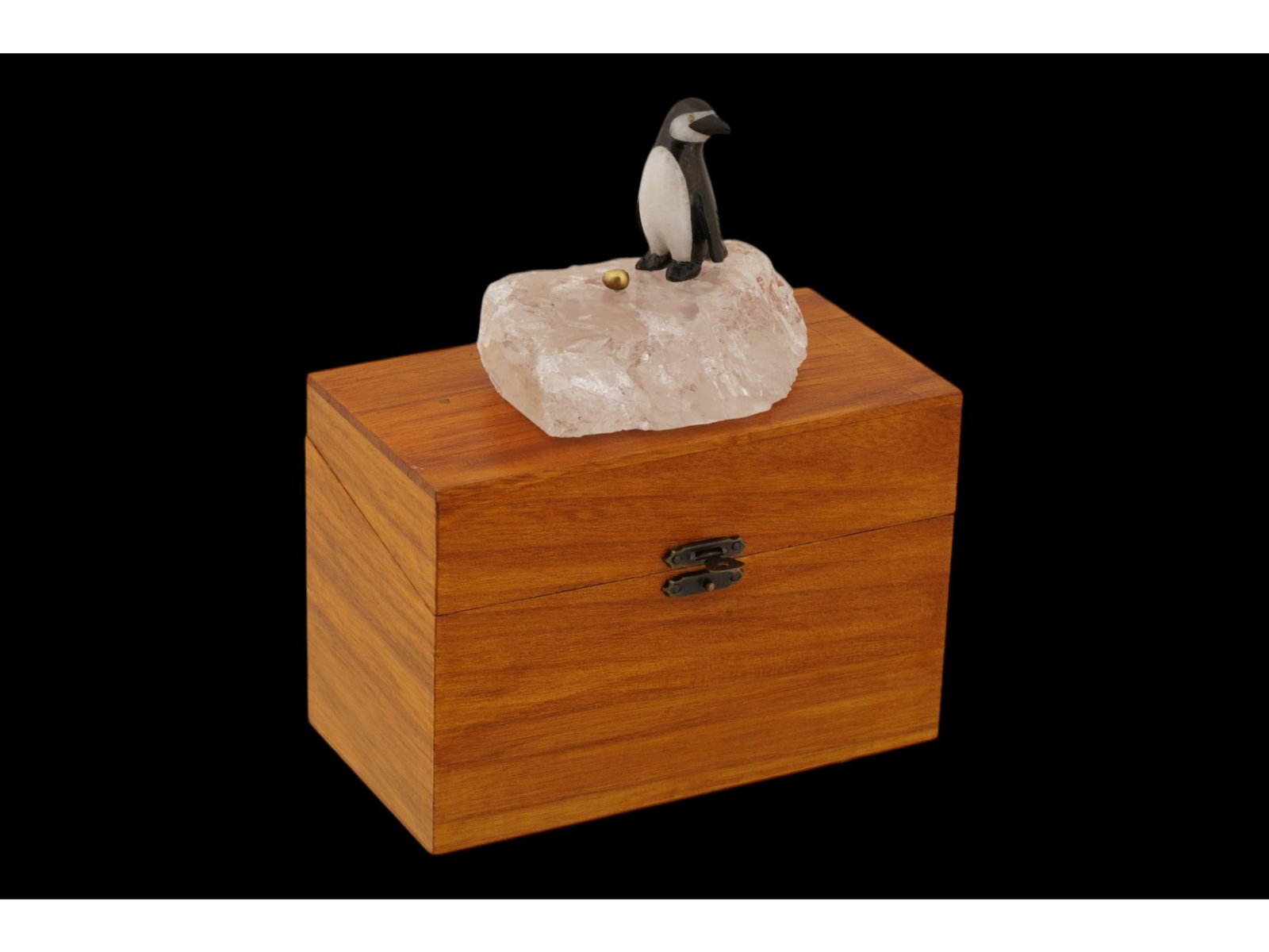 RUSSIAN ROCK CRYSTAL PAPERWEIGHT PENGUIN W DIAMOND EYES: A Russian hardstone penguin paperweight, expertly carved from natural rock crystal and depicted holding a gilt silver egg. The detailed figure is set with rose-cut diamond eyes. Hallmarked with the