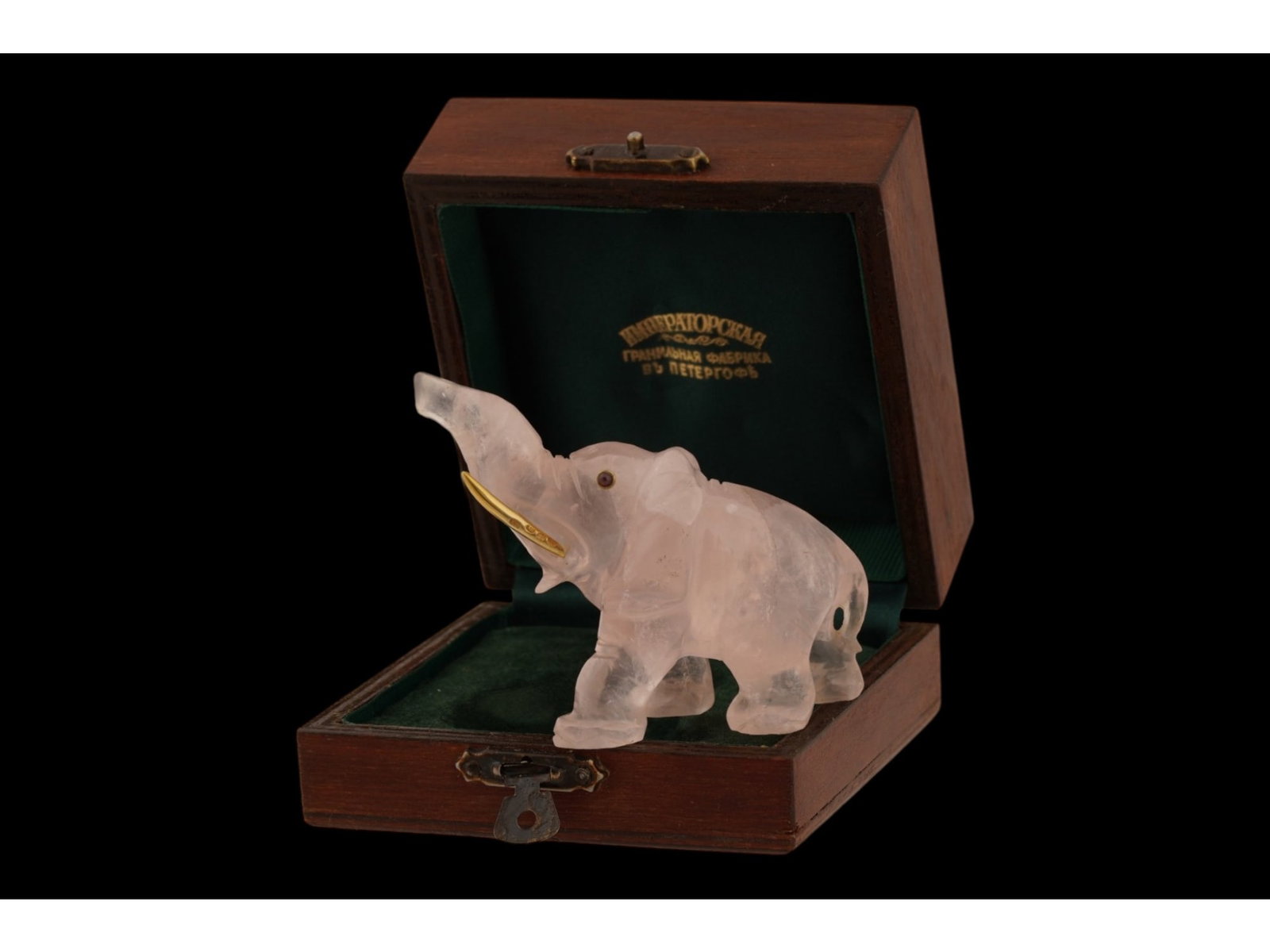 ANTIQUE RUSSIAN QUARTZ FIGURINE ELEPHANT W GARNET EYES: An antique Russian carved rose quartz elephant figurine, sculpted from natural gemstone with a raised trunk. The figure is detailed with cabochon garnet eyes and gilt silver tusks. Hallmarked with the