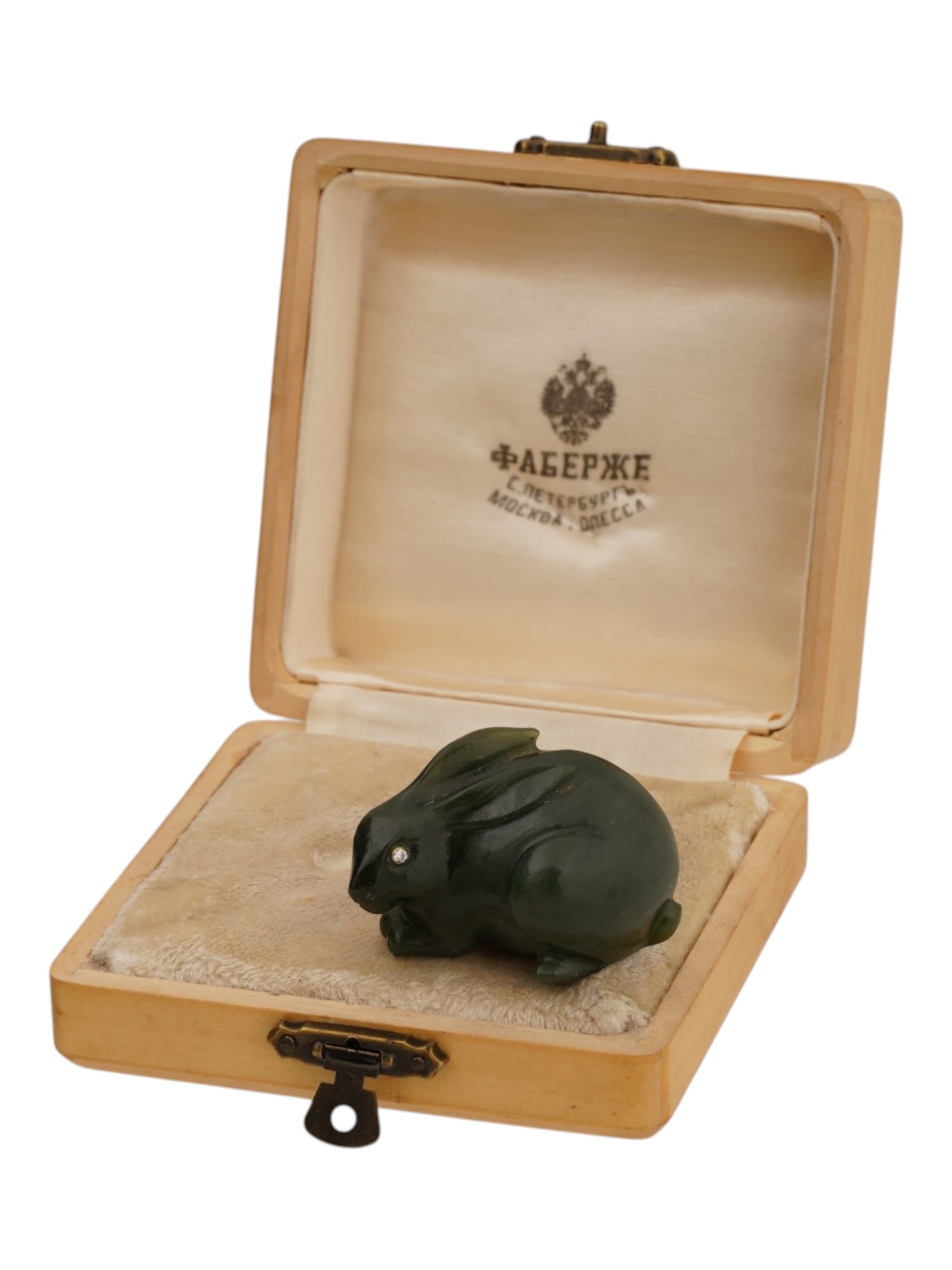 RUSSIAN CARVED JADE FIGURINE OF A HARE W DIAMOND EYES: A Russian carved jade figurine of a hare. Diamond eyes in gold fittings. Unmarked. Total Weight: 55 g. The piece comes in a fitted box. Collectible Russian Jewelry And Decor. THIS LOT IS ELIGIBLE FOR 