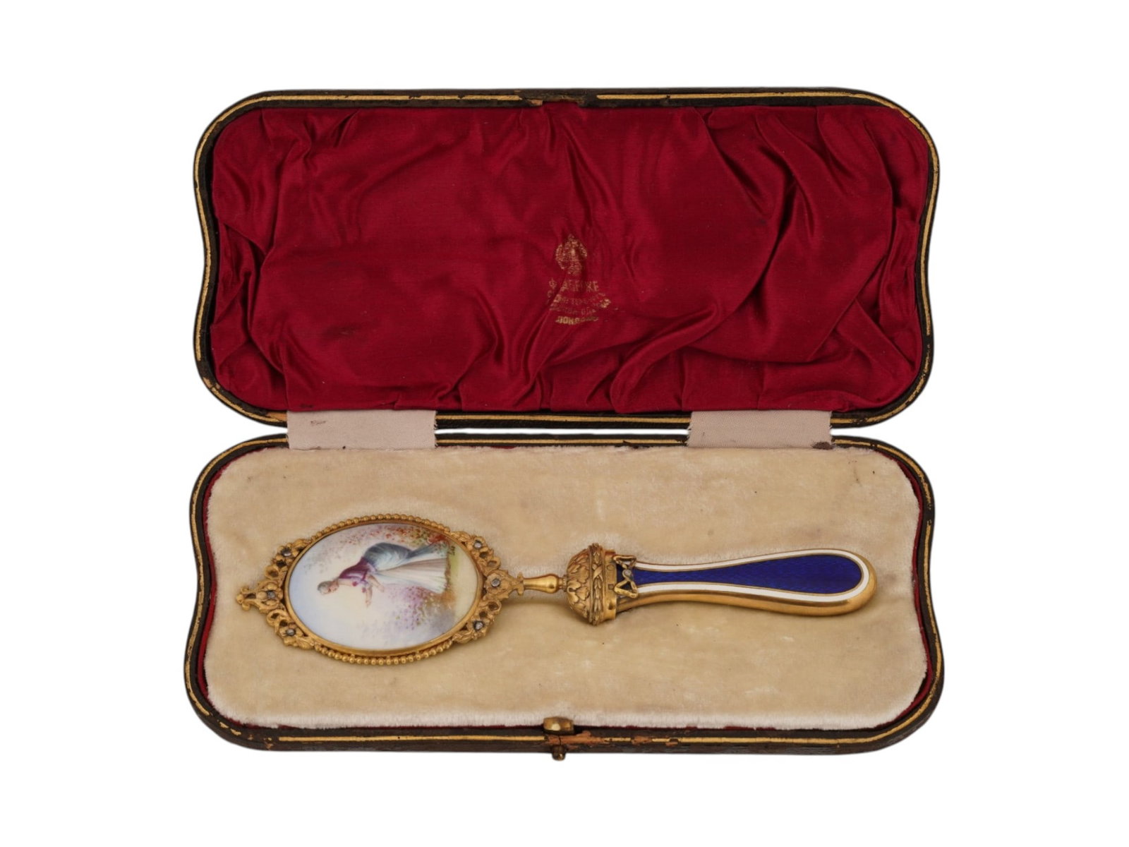 RUSSIAN GOLD PORCELAIN ENAMEL DIAMOND HAND MIRROR: A Russian gold hand mirror. The oval body is encompassed with diamond-set flowers and beaded strings. The porcelain backing of the mirror represents a hand-painted portrait of a woman in a garden, sig