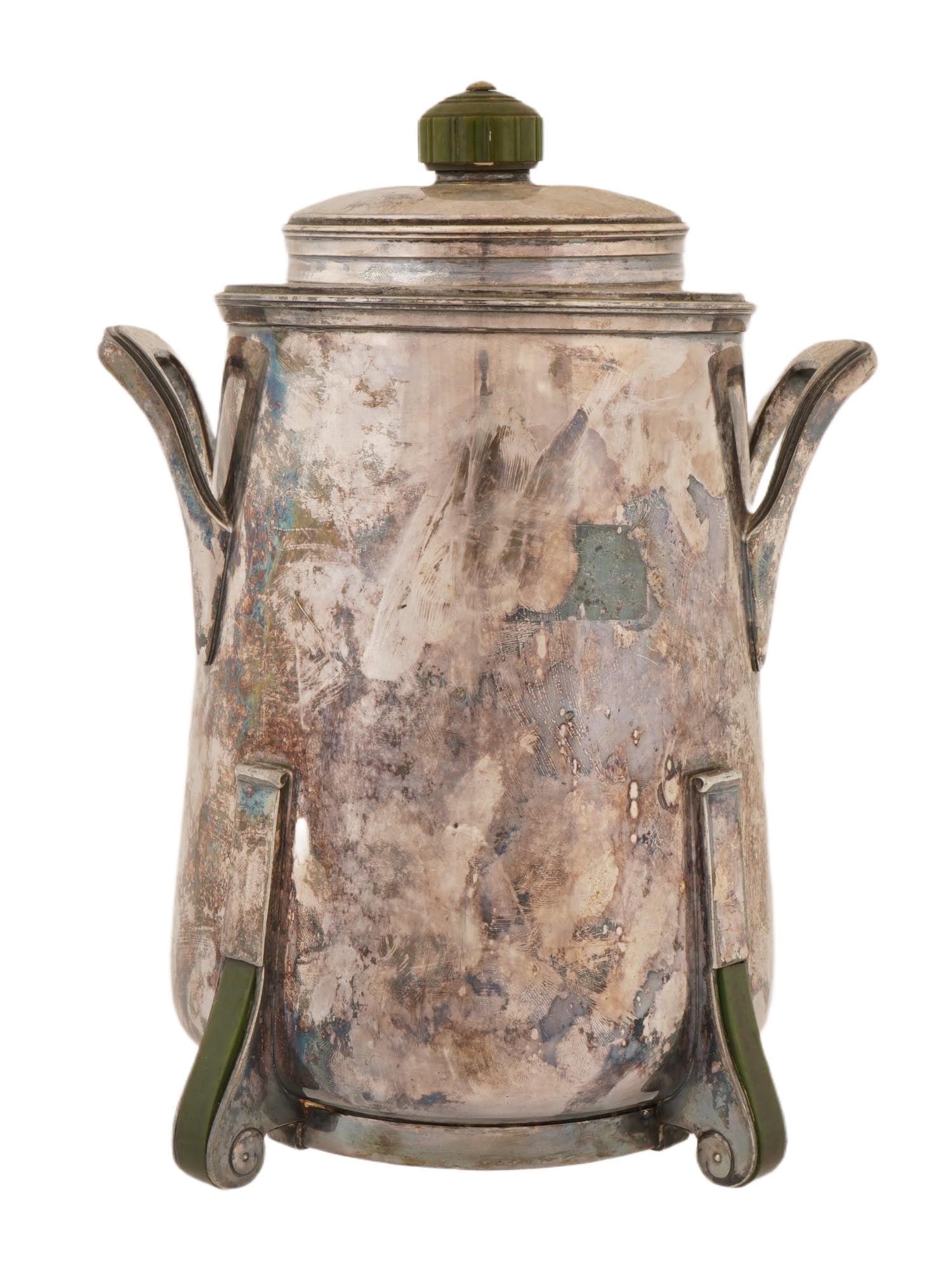 ANTIQUE AMERICAN ART DECO SILVER PLATED THERMOS HOLDER: An antique American Art Deco silver plated and bakelite thermos holder. Circa the early 20th century. The antique thermos, slightly flared at the bottom, with two side handles and a lid. It stands on 