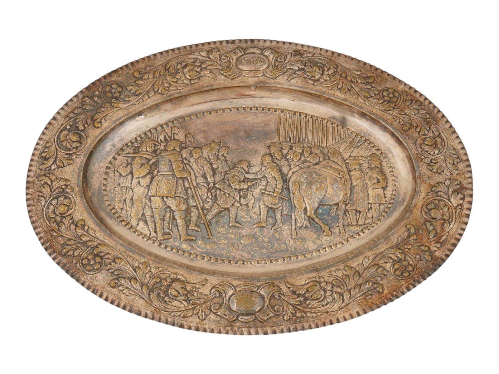ANTIQUE SPANISH DIEGO VELAZQUEZ SILVER PLATED CHARGER: An antique decorative silver-plated charger depicting a relief scene after Diego Velazquezs celebrated The Surrender of Breda, painted circa 1635. The central composition portrays Justinus van Nassau 