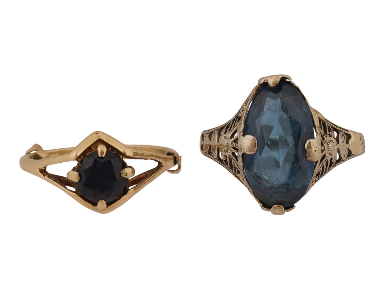 PAIR OF VINTAGE 14K GOLD SAPPHIRE COCKTAIL RINGS: A pair of vintage cocktail rings. 14K white gold ring with a large oval-cut cornflower blue sapphire and decorative openwork to the sides. 14K yellow gold ring with a classic round-cut deep blue sapph