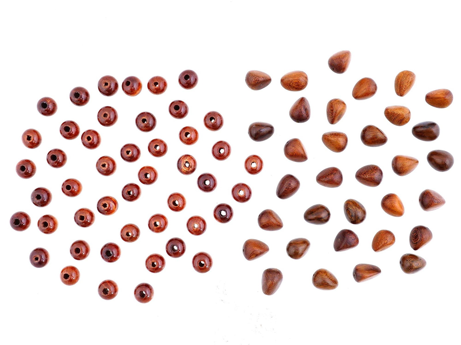 COLLECTION OF ASSORTED HAND CARVED WOODEN BEADS: A collection of assorted hand carved wooden beads. The beads are made in various sizes and shapes, mostly circular, and oval. Vintage and Modern Carved Wood Beads, Amulets, Accessories, and Collectibl