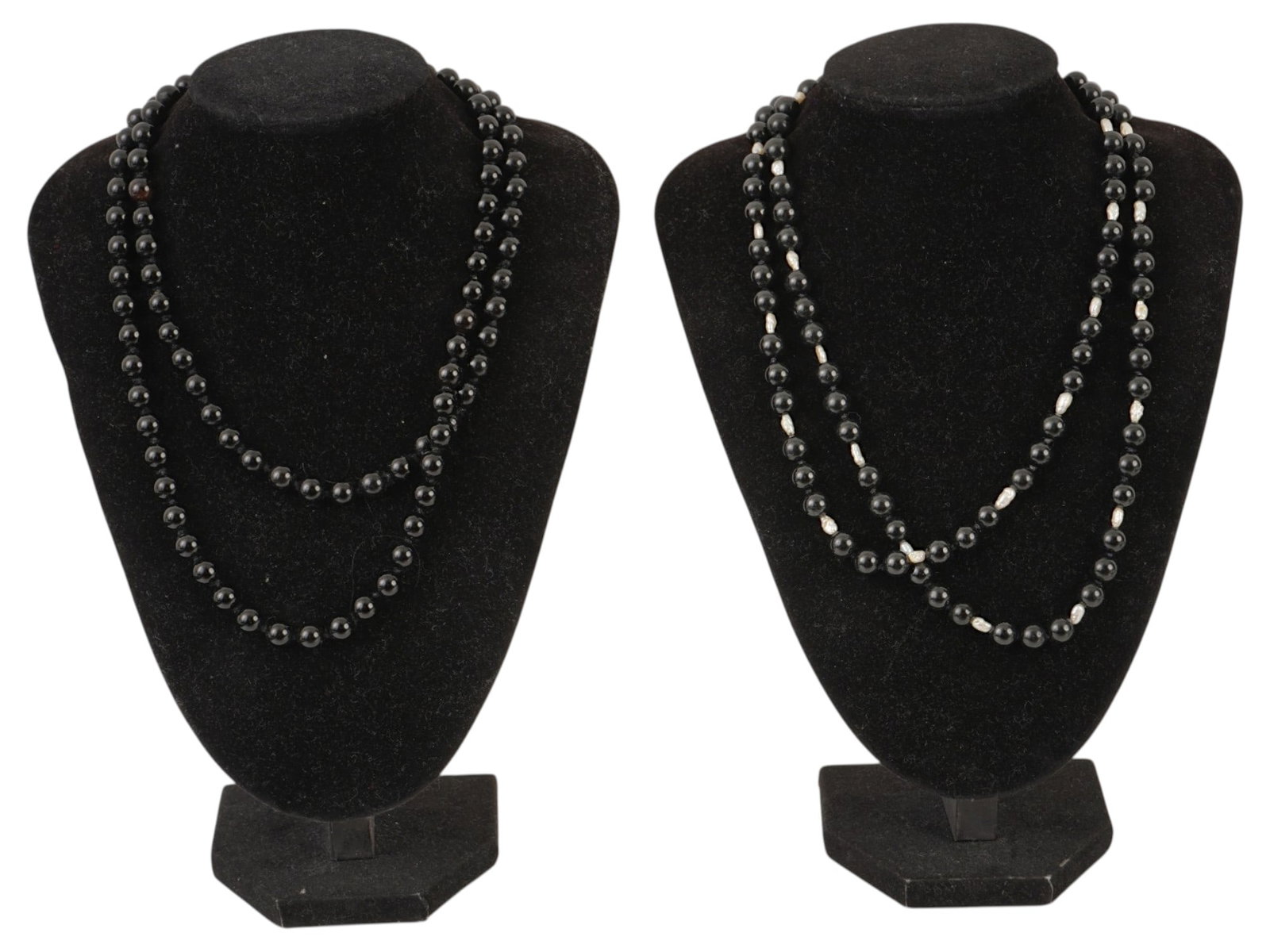 PAIR OF VINTAGE FLAPPER STYLE COSTUME NECKLACES: A pair of vintage flapper-style costume necklaces featuring elegant opera-length strands of polished black beads. One necklace is composed entirely of glossy black beads, while the other incorporates 
