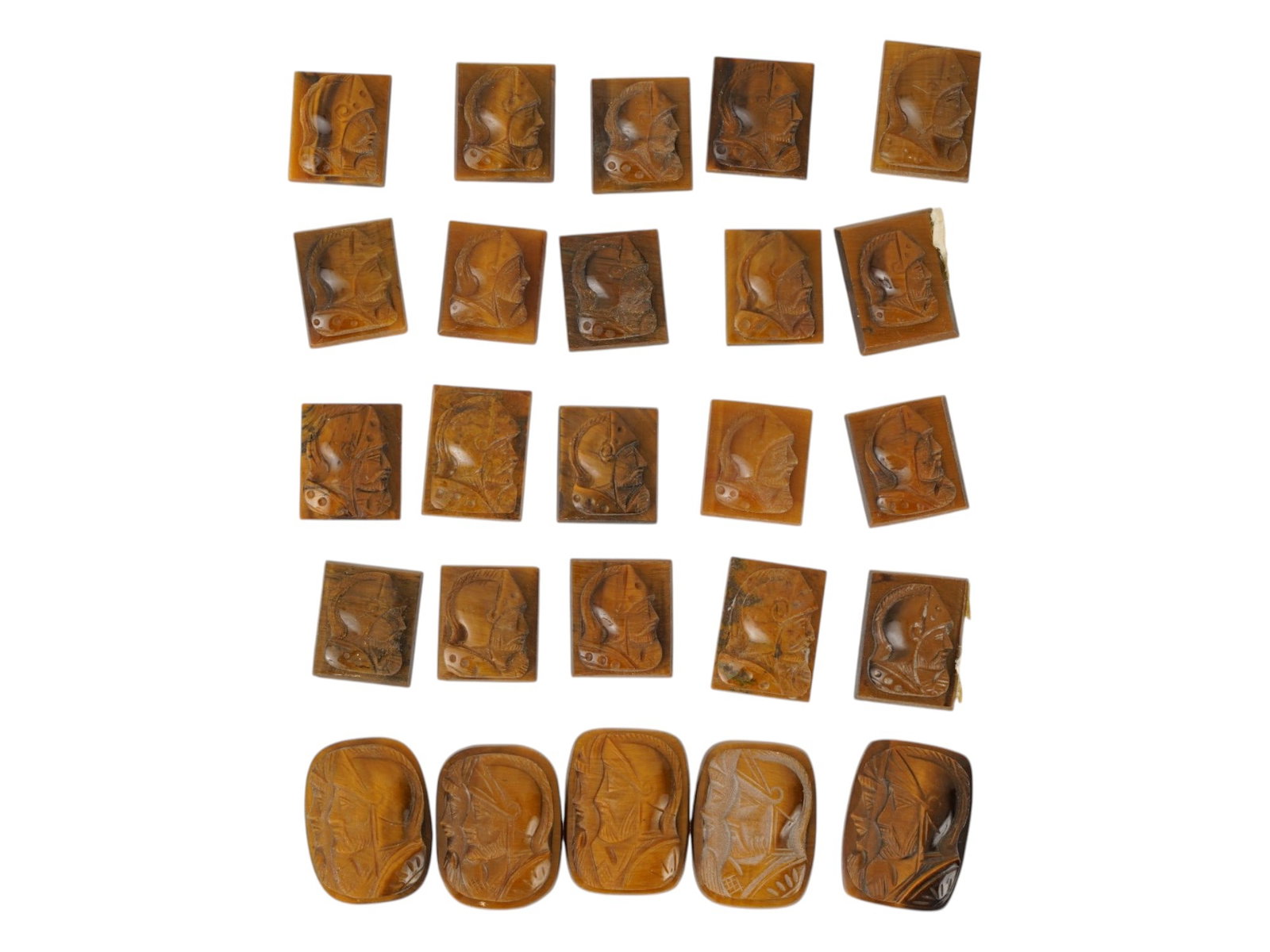 COLLECTION OF PORTRAIT HAND CARVED TIGERS EYE CAMEOS: A collection of twenty five hand carved tigers eye cameo medallions. The lot includes oval and rectangular carvings depicting single and double profile armored warriors in the Roman manner. Made for r