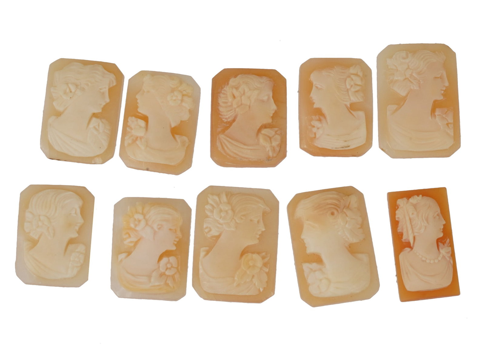 COLLECTION OF CARVED FEMALE PORTRAIT SHELL CAMEOS: A collection of hand carved shell cameos. A total of 10 items. Each piece depicts a female profile portrait rendered in high relief in the Victorian and Roman manners. Each cameo is fashioned in disti
