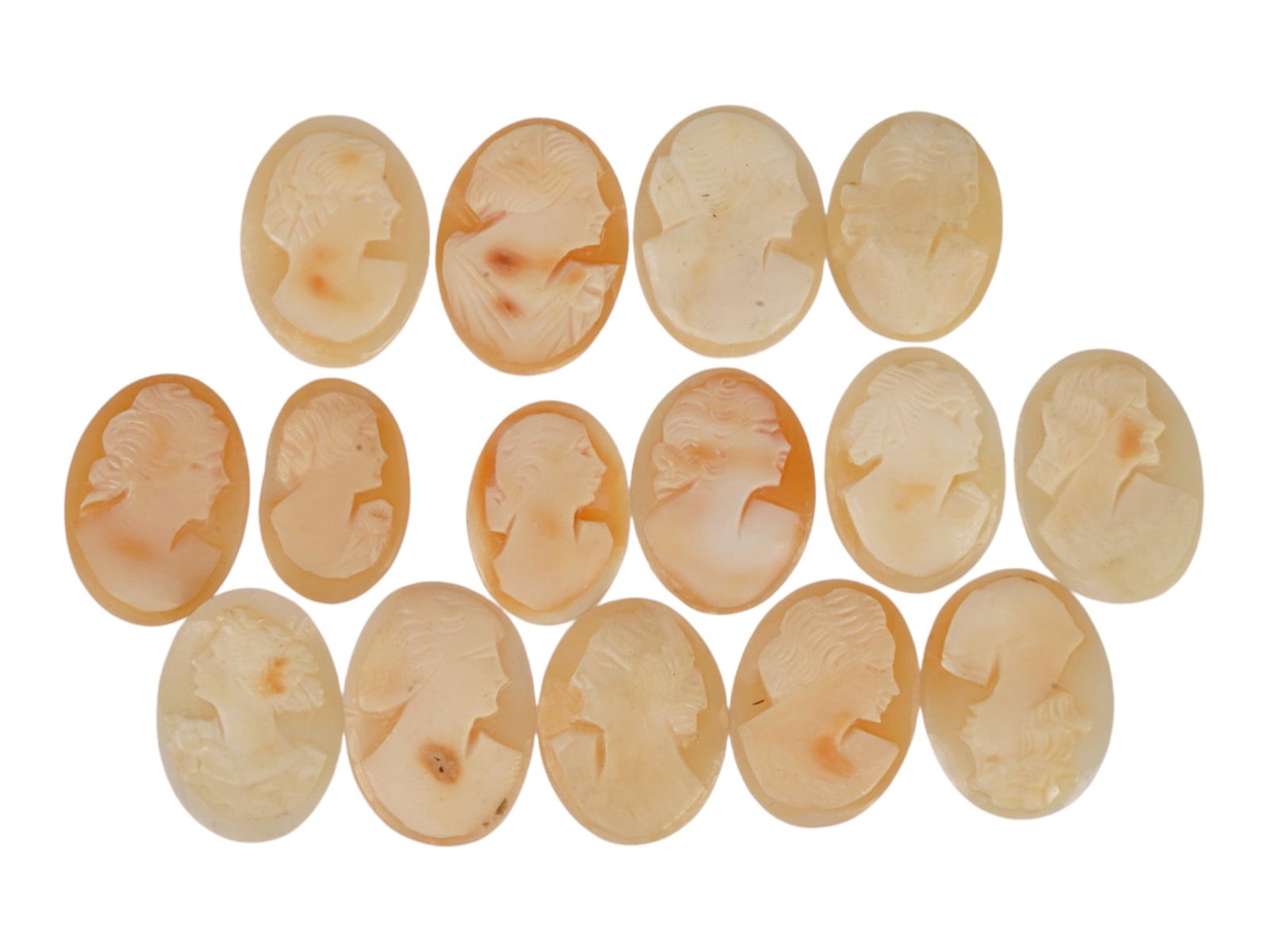 COLLECTION OF CARVED FEMALE PORTRAIT SHELL CAMEOS: A collection of hand carved shell cameos. A total of 15 items. Each piece depicts a female profile portrait rendered in high relief in the Victorian and Roman manners. Each cameo is fashioned in a dis