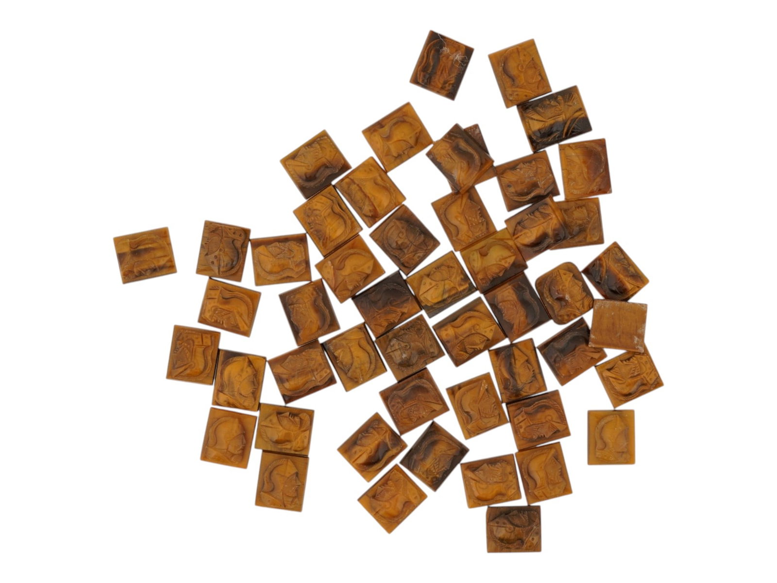 COLLECTION OF PORTRAIT CARVED TIGERS EYE CAMEOS: A collection of hand carved tigers eye cameos. A total of 50 items. Each piece features a double knight profile portrait rendered in high relief. Rectangular shape. Collectible Jewelry And Glyptic Art