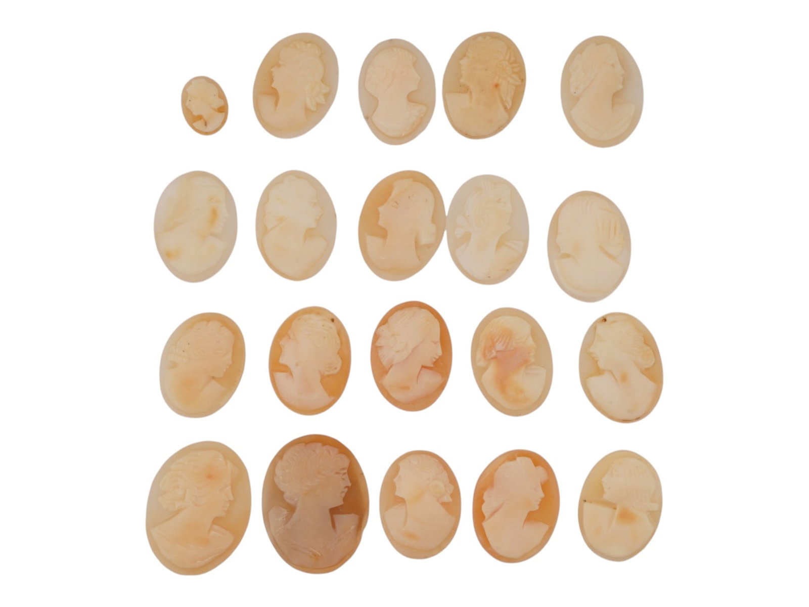 COLLECTION OF HAND CARVED SHELL CAMEO MEDALLIONS: A collection of vintage hand carved cameo medallions. A total of 20 items. Each piece is crafted from conch shell featuring a female portrait in the Victorian manner rendered in high relief. The cameo