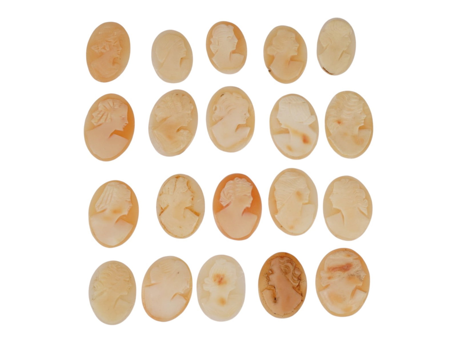 LOT OF FEMALE PORTRAIT CARVED SHELL CAMEOS: A lot of 20 hand carved conch shell cameos. Each piece depicts a female profile portrait rendered in high relief. Oval shape. Collectible Jewelry And Glyptic Art, Sculpture. THIS LOT IS ELIGIBLE FOR A
