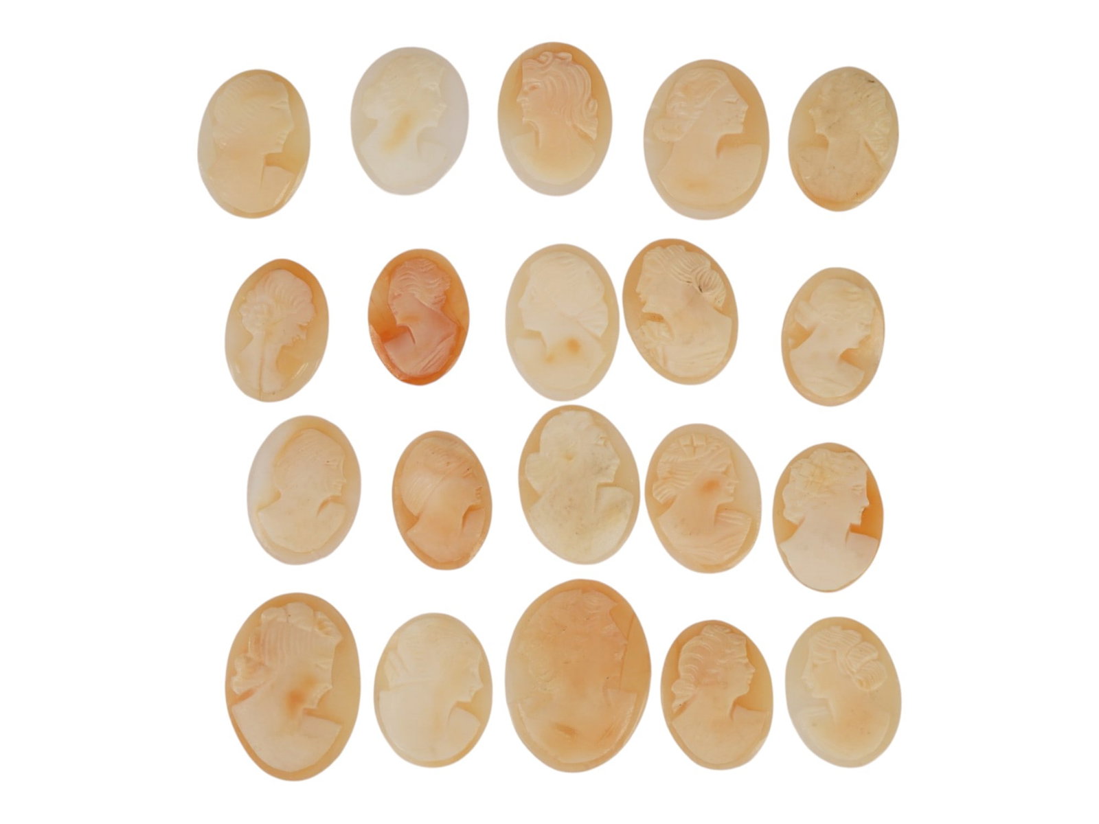 COLLECTION OF 20 UNMOUNTED VINTAGE SHELL CAMEOS: A collection of twenty unmounted vintage shell cameos, hand-carved with classical female profiles in traditional glyptic style. The group displays varied relief depths, distinctive hairstyles, floral 