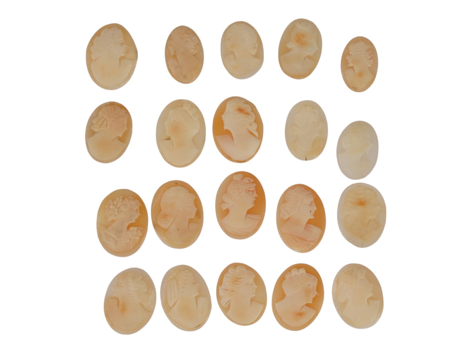 COLLECTION OF 20 UNMOUNTED VINTAGE SHELL CAMEOS: A collection of twenty unmounted vintage shell cameos, hand-carved with classical female profiles in traditional glyptic style. The group displays varied relief depths, distinctive hairstyles, floral 