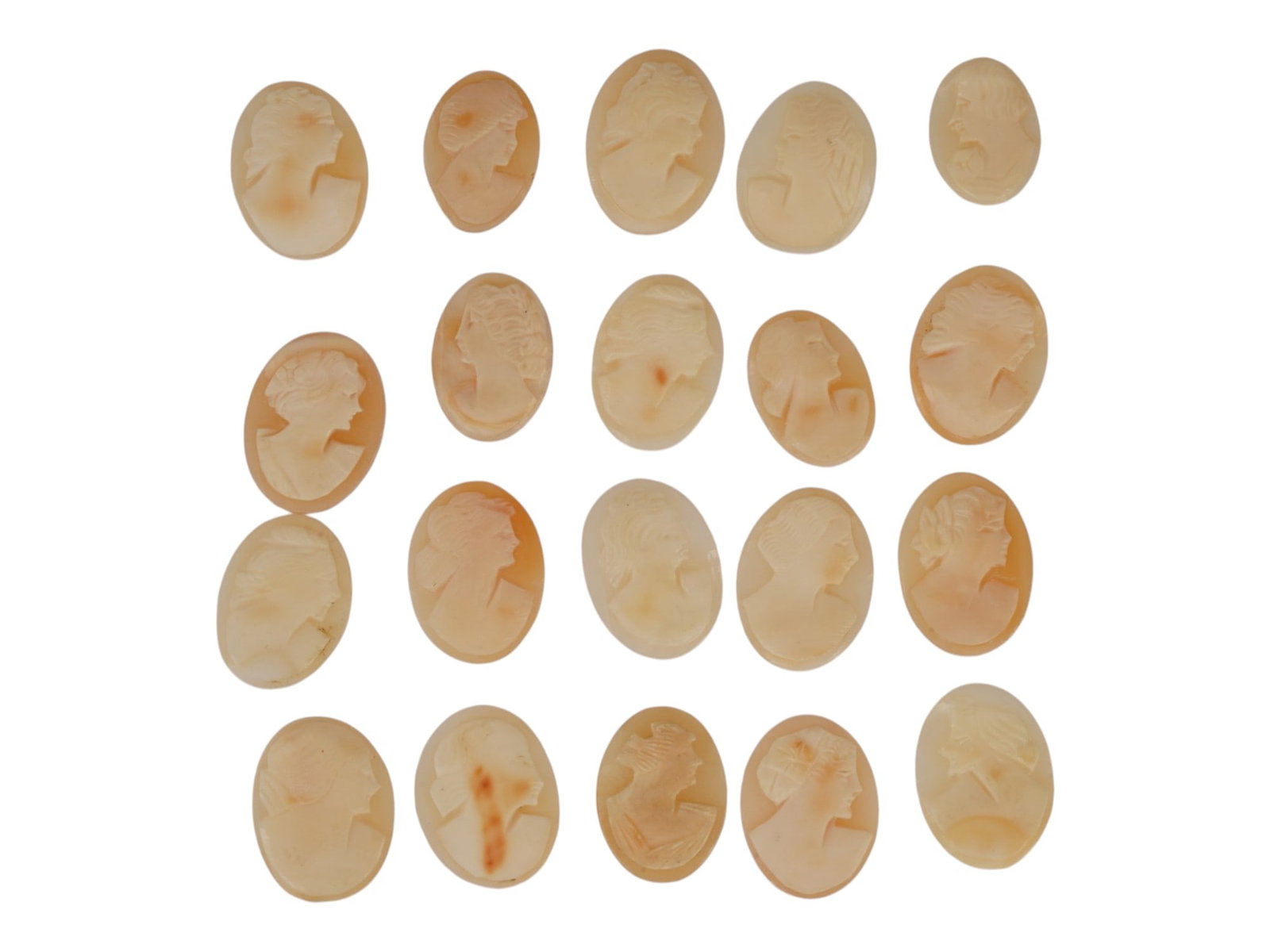 LOT OF FEMALE PORTRAIT CARVED SHELL CAMEOS: A lot of 20 hand carved conch shell cameos. Each piece depicts a female profile portrait rendered in high relief. Oval shape. Collectible Jewelry And Glyptic Art, Sculpture. THIS LOT IS ELIGIBLE FOR A