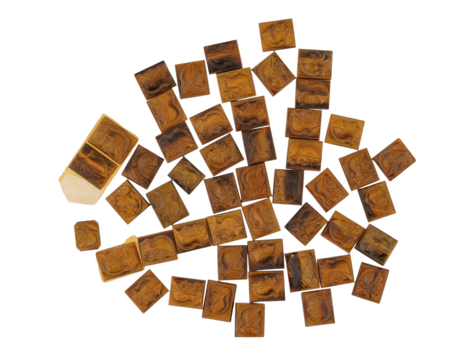 COLLECTION OF PORTRAIT CARVED TIGERS EYE CAMEOS: A collection of hand carved tigers eye cameos. Each piece features a knight profile portrait rendered in high relief. Rectangular shape. Collectible Jewelry And Glyptic Art, Sculpture, Mineral Stones.