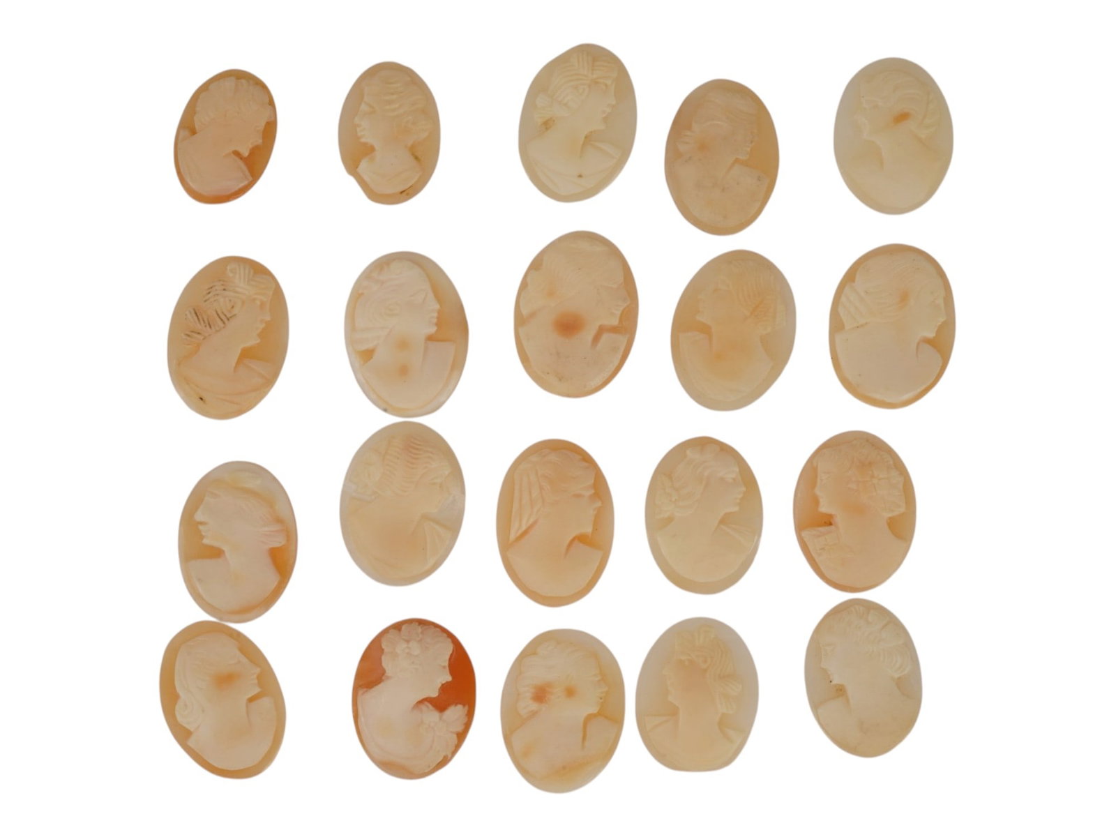 COLLECTION OF HAND CARVED SHELL CAMEO MEDALLIONS: A collection of vintage hand carved cameo medallions. A total of 20 items. Each piece is crafted from conch shell featuring a female portrait in the Victorian manner rendered in high relief. The cameo