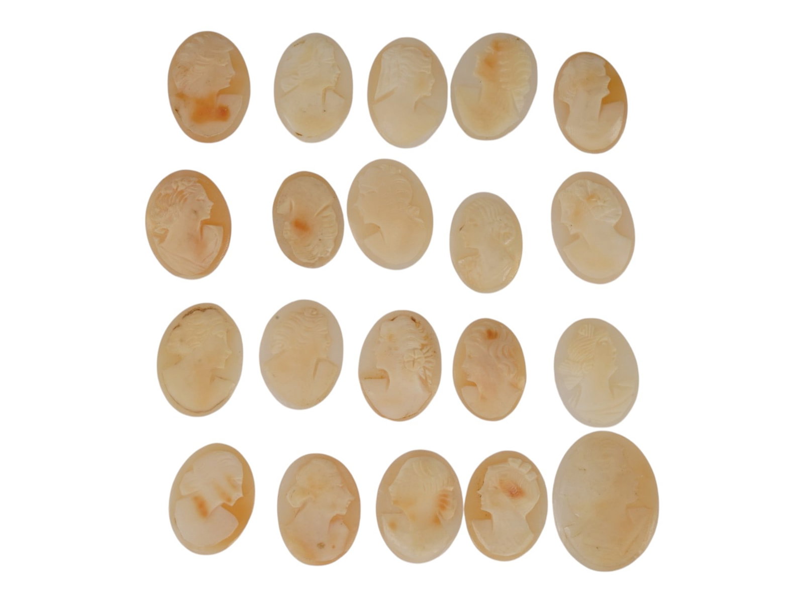 COLLECTION OF HAND CARVED SHELL CAMEO MEDALLIONS: A collection of vintage hand carved cameo medallions. A total of 20 items. Each piece is crafted from conch shell featuring a female portrait in the Victorian manner rendered in high relief. The cameo
