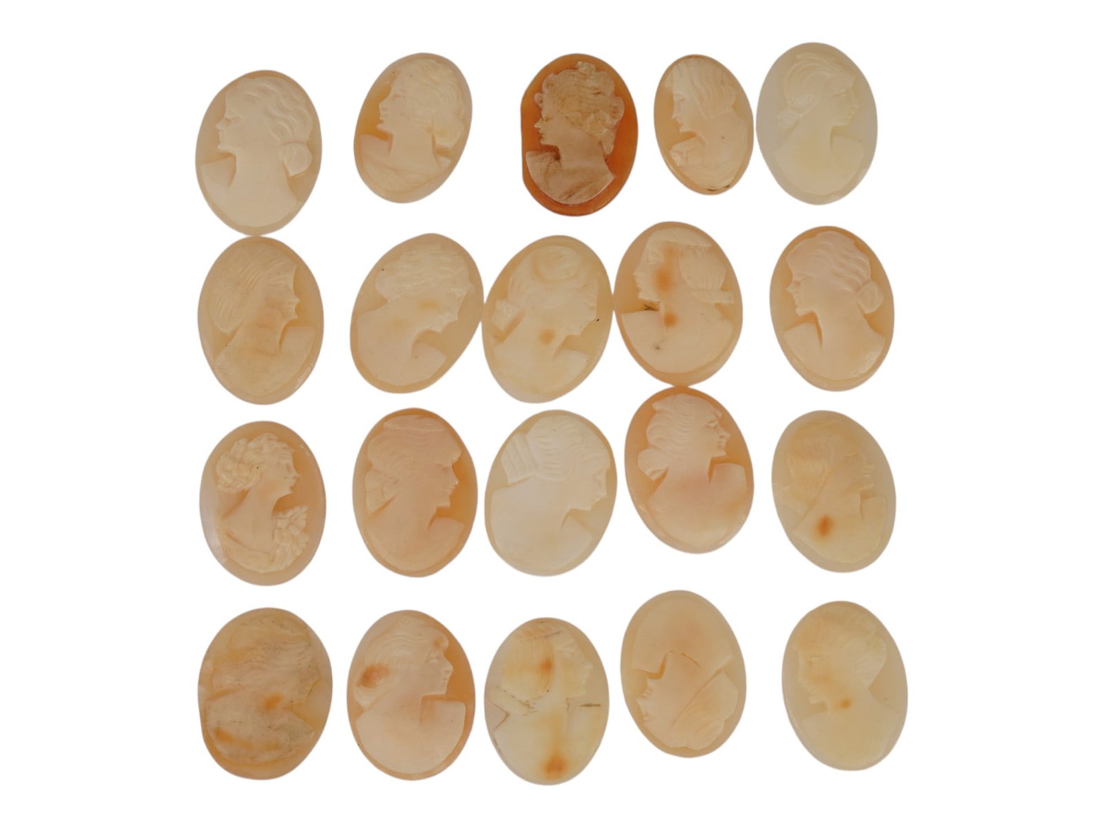 COLLECTION OF HAND CARVED SHELL CAMEO MEDALLIONS: A collection of vintage hand carved cameo medallions. A total of 20 items. Each piece is crafted from conch shell featuring a female portrait in the Victorian manner rendered in high relief. The cameo