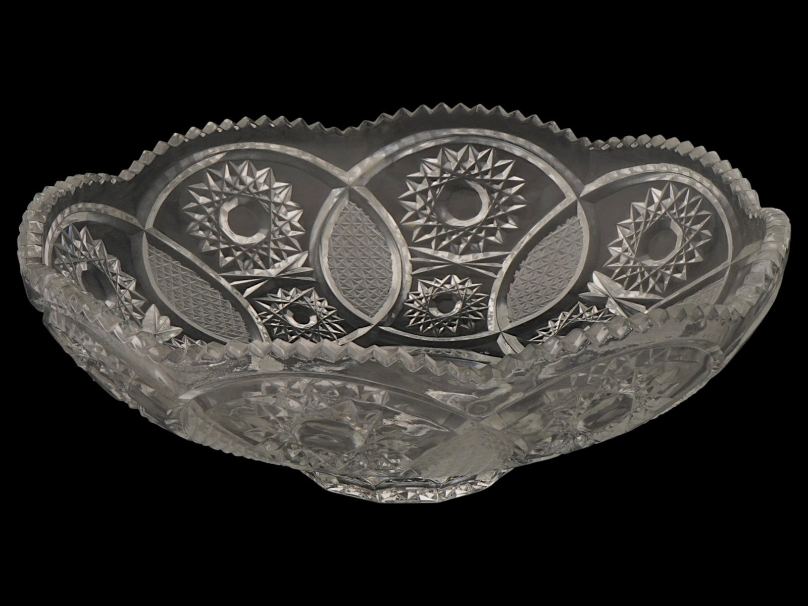 VINTAGE CUT LEAD CRYSTAL FRUIT BOWL: A vintage clear lead crystal fruit bowl. Footed round piece with jagged figurative rim. Carved hobstar and crosshatching patterns. Unmarked. Collectible Glassware, Crystal, Home Decor, Tableware. THIS