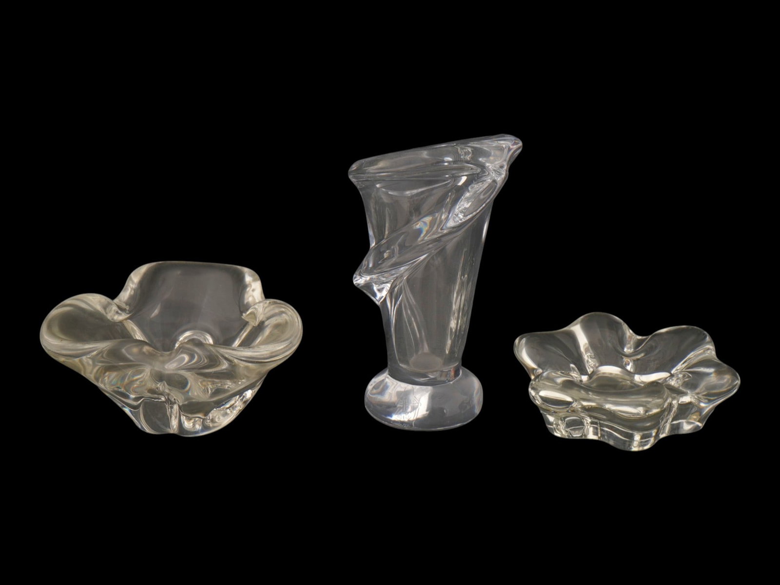 VINTAGE FRENCH CRYSTAL ART GLASS VASE AND BOWLS: A lot of three vintage French crystal art glass pieces. The lot includes Vannes Le Chatel calla lily Shaped vase and two small bowls in a wavy design, one of which by Sevres. Collectible Glassware, Va