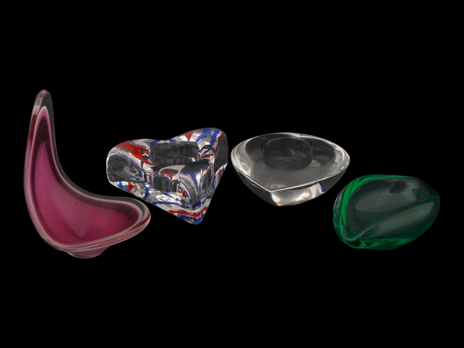 COLLECTION OF FOUR LOVE DESIGN ART GLASS PIECES: A collection of four art glass wares made in a Love design. The collection includes a tall, asymmetrical, petal shaped bud vase made of two layer raspberry pink and clear glass, crafted using the free