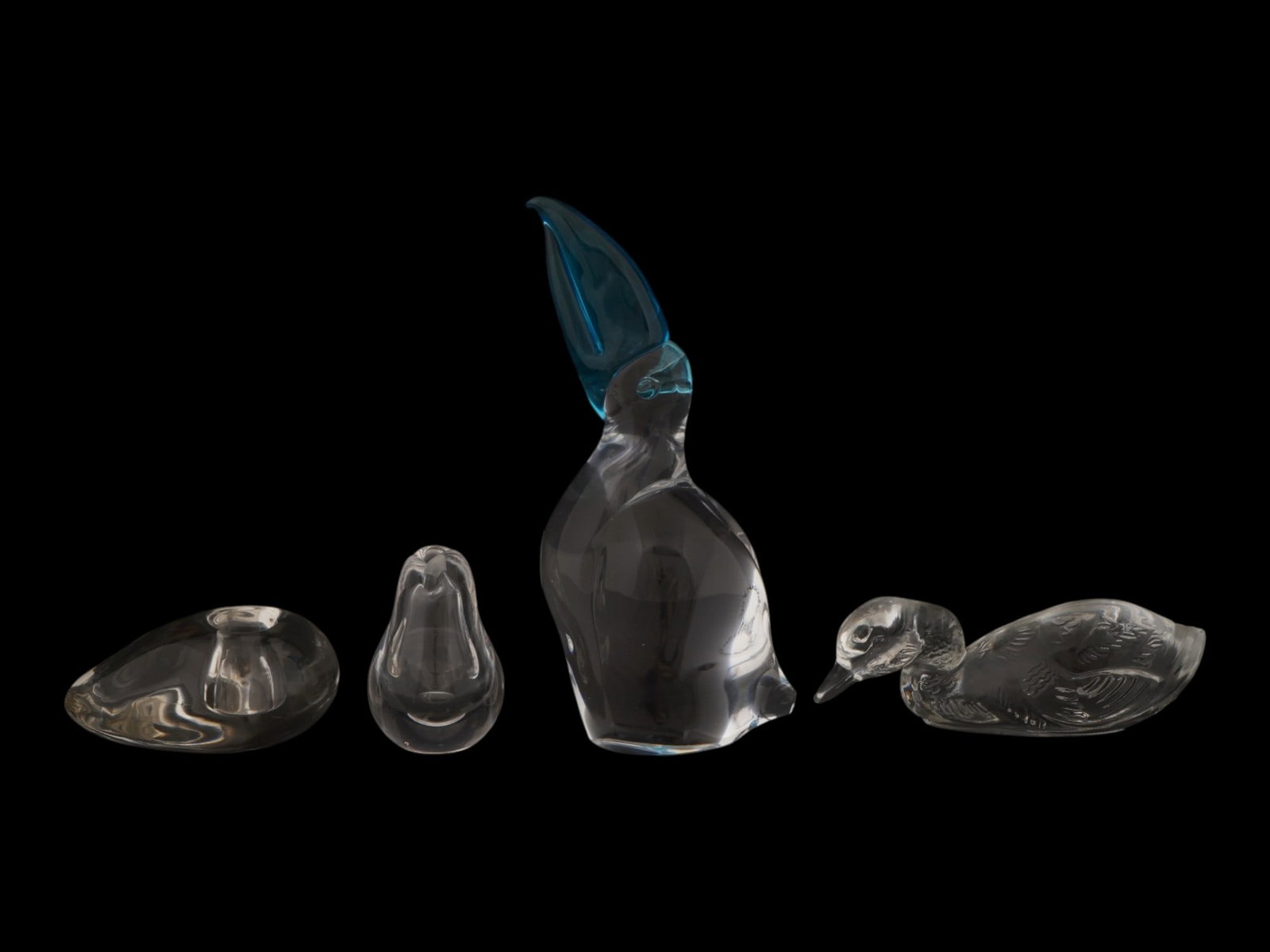 ART GLASS FIGURINES BY PERETTI KOSTA BODA AND MURANO: A collection of four vintage art glass figurines and interior decor items. The collection includes a candle holder or ashtray made of solid, clear glass with a streamlined, organic shape, marked with 