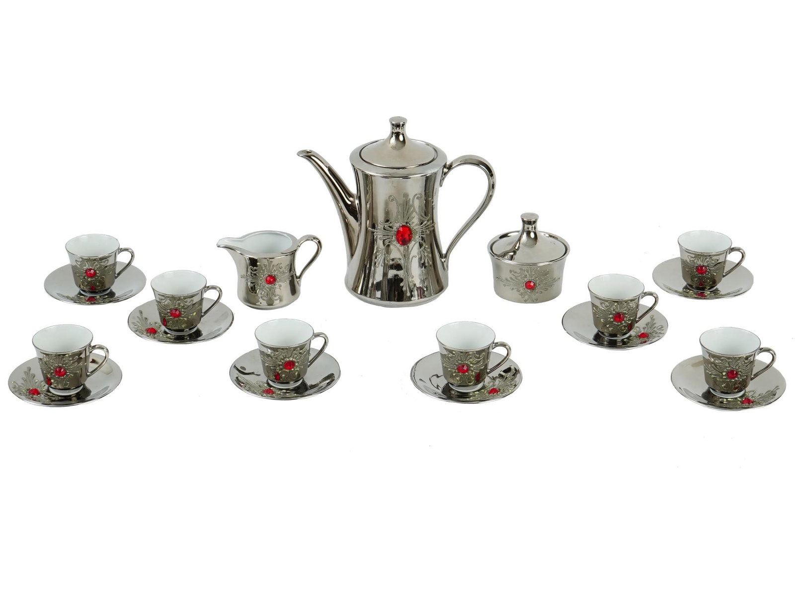 MID CENT SELTMANN WEIDEN GERMAN PORCELAIN TEA SET: A mid 20th century West German porcelain silver tone tea set. The tea set has an interesting design, the outer side of each item is silver in tone with the image of a stylized star in the center of wh