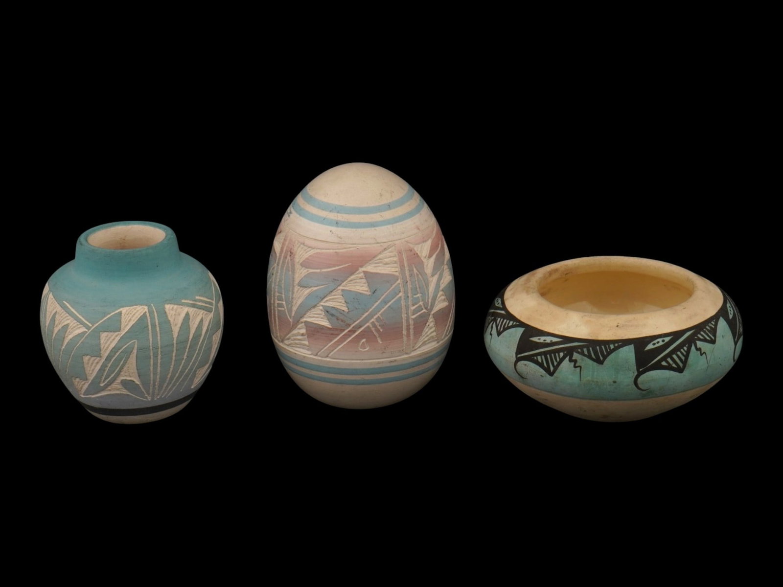 LOT OF THREE AMERICAN FOLK ART CERAMIC VESSELS SIGNED: A collection of three American ceramic vessels featuring traditional geometric motifs and various decorative techniques. The first: a turquoise slipped jar with white sgraffito patterning, inscribed, 