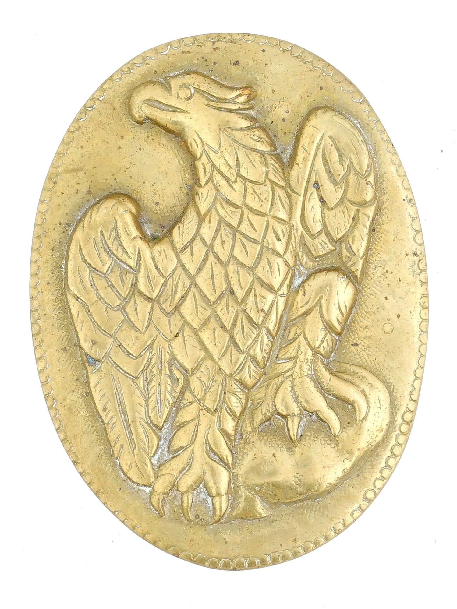 GERMAN RELIEF EAGLE PATINATED BRONZE PAPERWEIGHT: A vintage German gilt patinated bronze plaque paperweight. The ware is adorned with a relief image of an eagle, engraved with detailed patterns. Marked, Ottavia, Germany, on the backside. Vintage and 