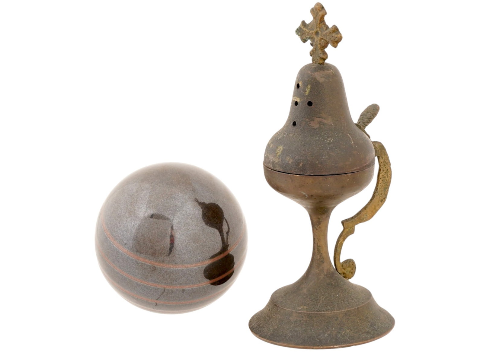 CAST METAL RELIGIOUS CENSER AND RESIN SPHERE: A lot of two items comprises a cast metal religious censer and a companion resin sphere. The censer features a footed base, an ornate scroll-style handle, and a hinged lid surmounted by a Latin cross 